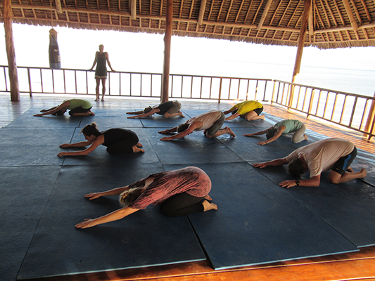 Practicing dynamic whole body stretches at Wildfitness Zanzibar
