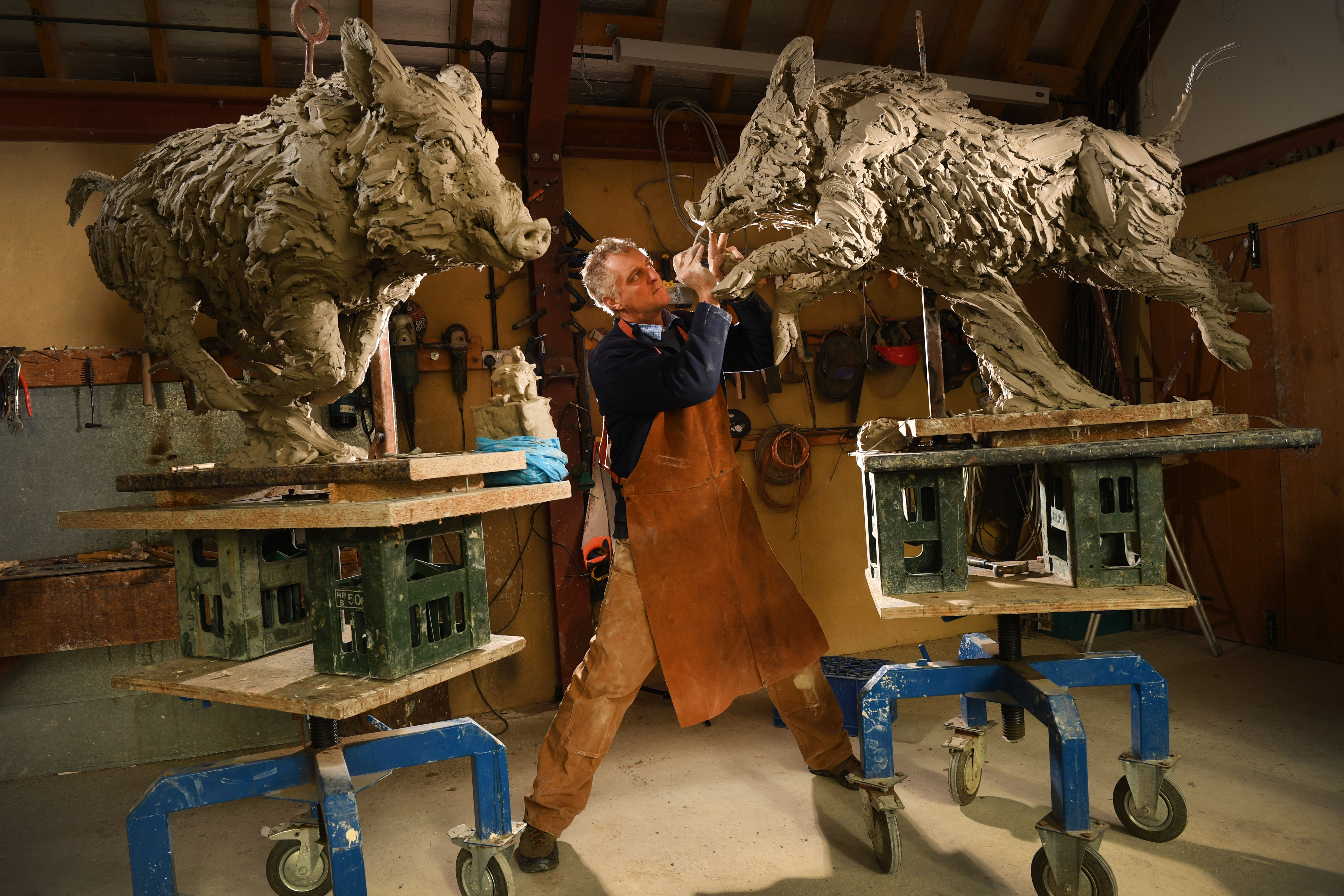 Hamish Mackie sculpting two wild boar