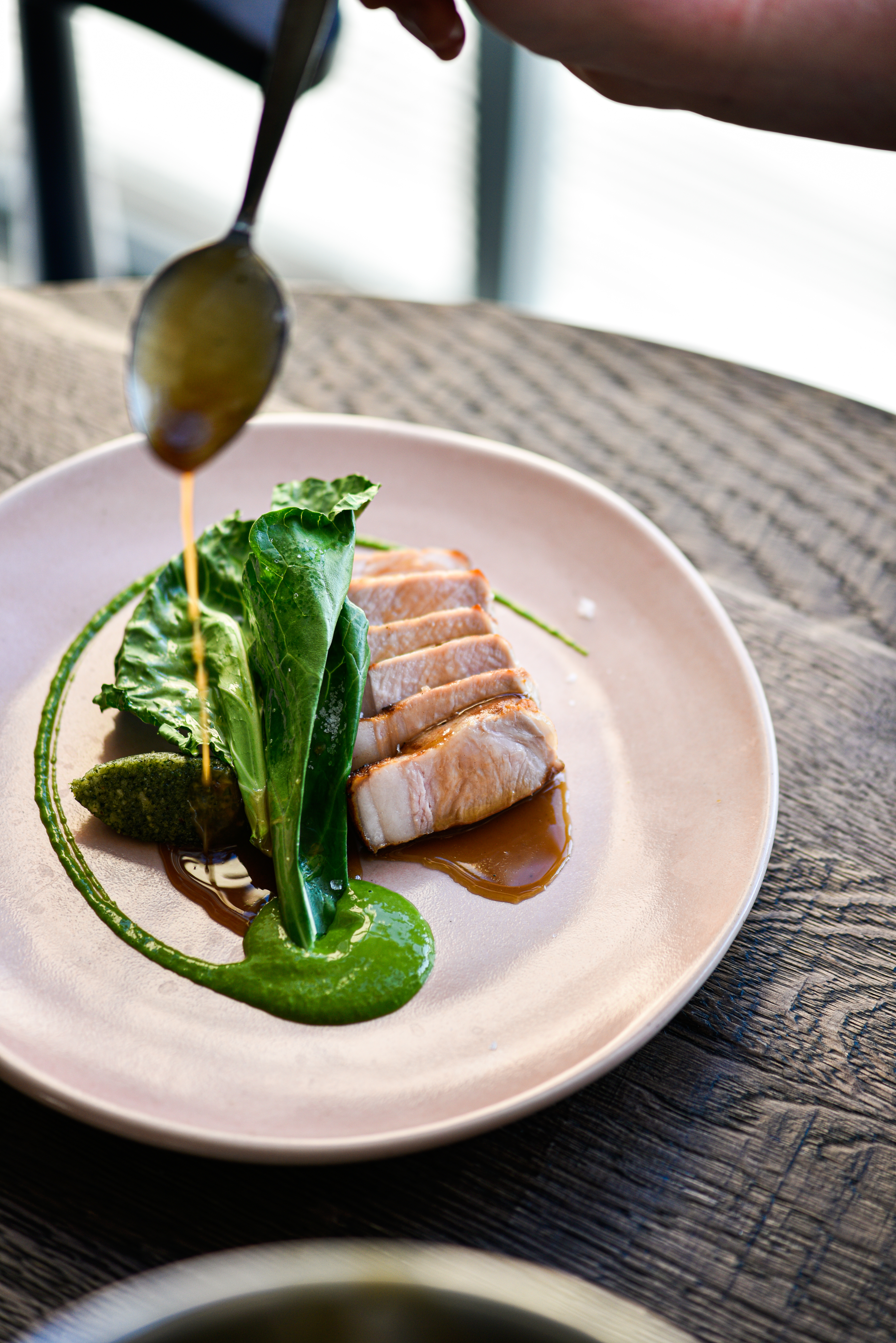 Pork loin spring greens with hazelnut pesto