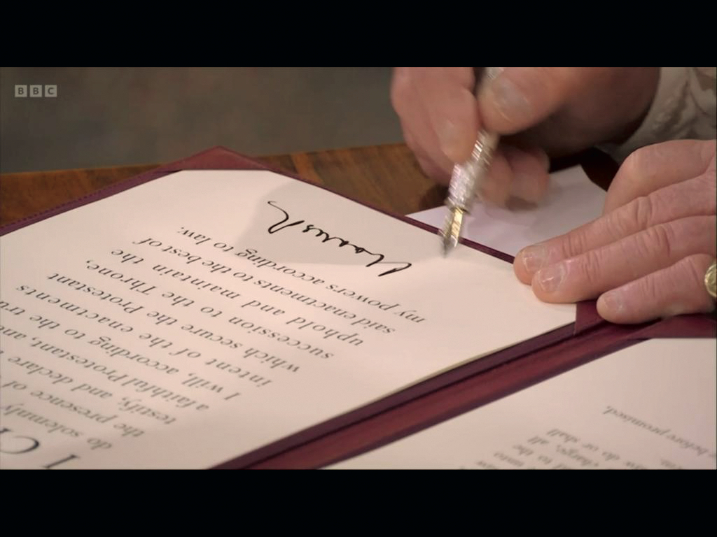 The King signs the Coronation Oath