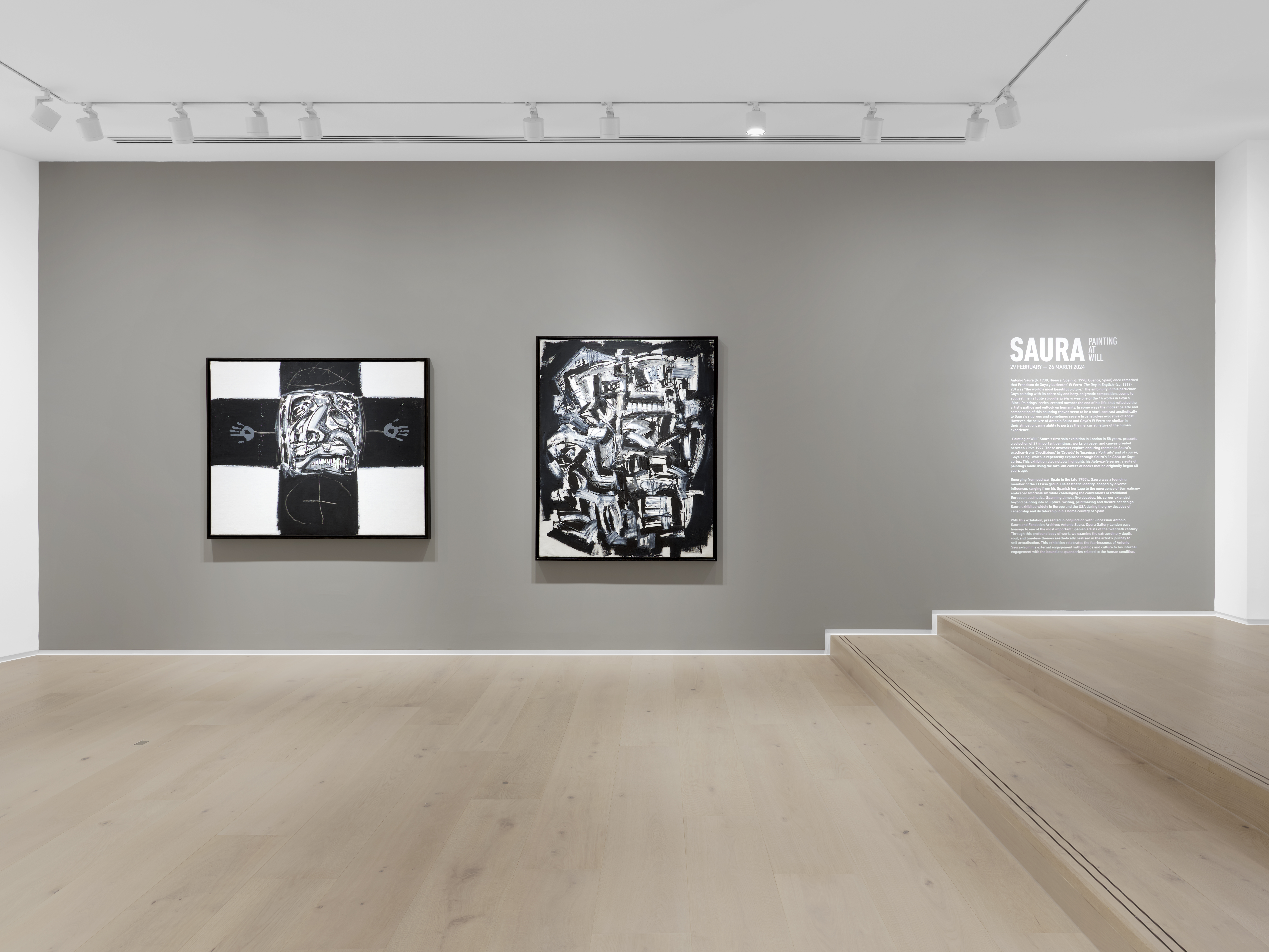 Antonio Saura - Two black and white paintings on a wall next to a written explanation