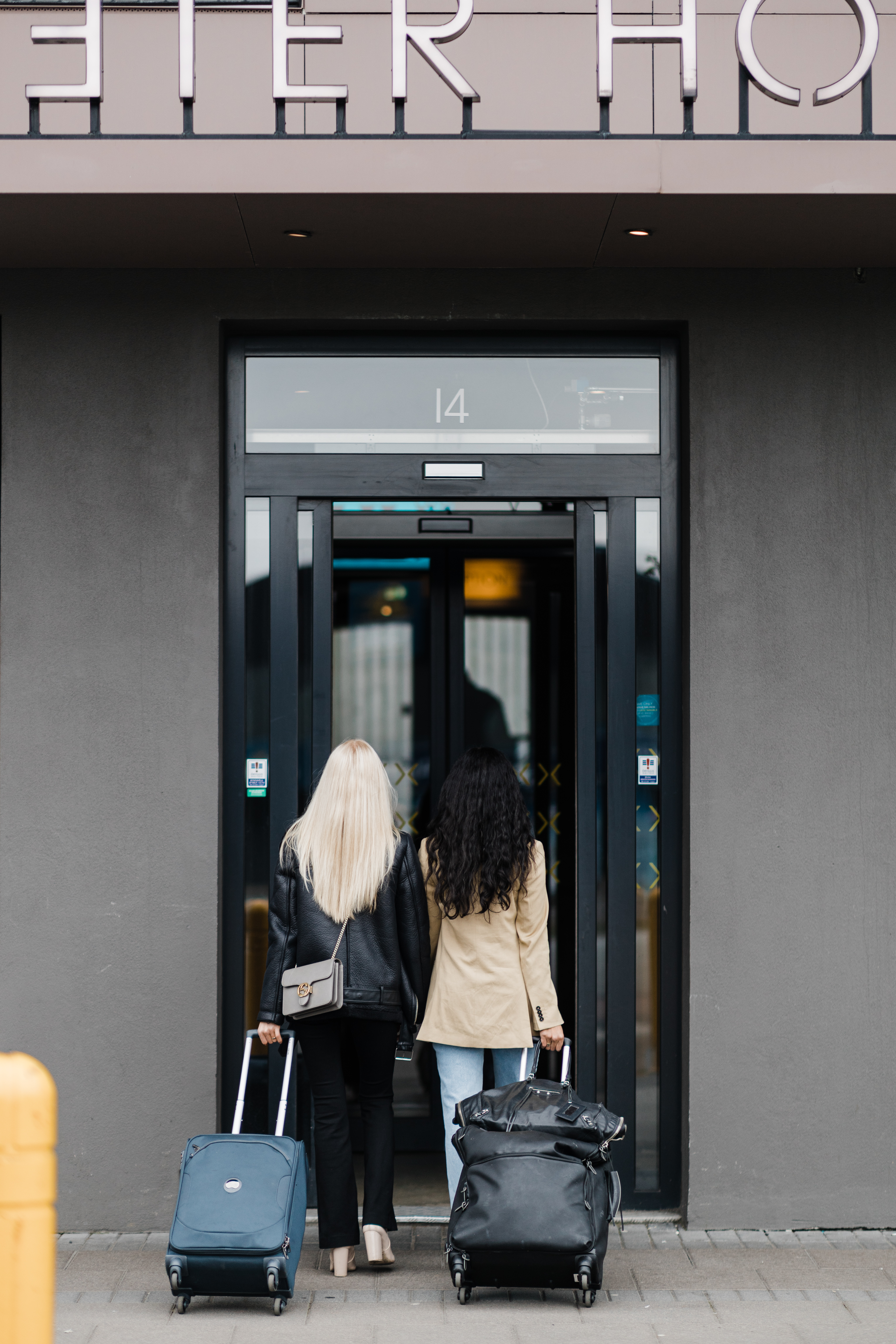 Exeter Hotel - entrance Exeter Hotel - two people walking through the entrance with luggage