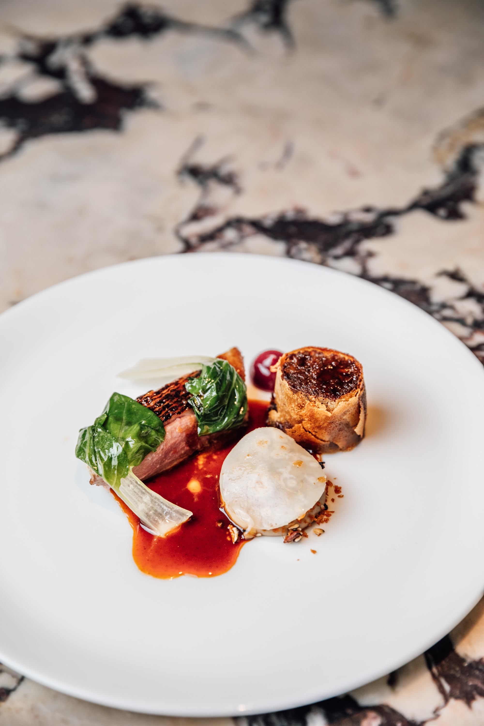 Royal Ascot Restaurants 2025 - a duck dish served on a white plate