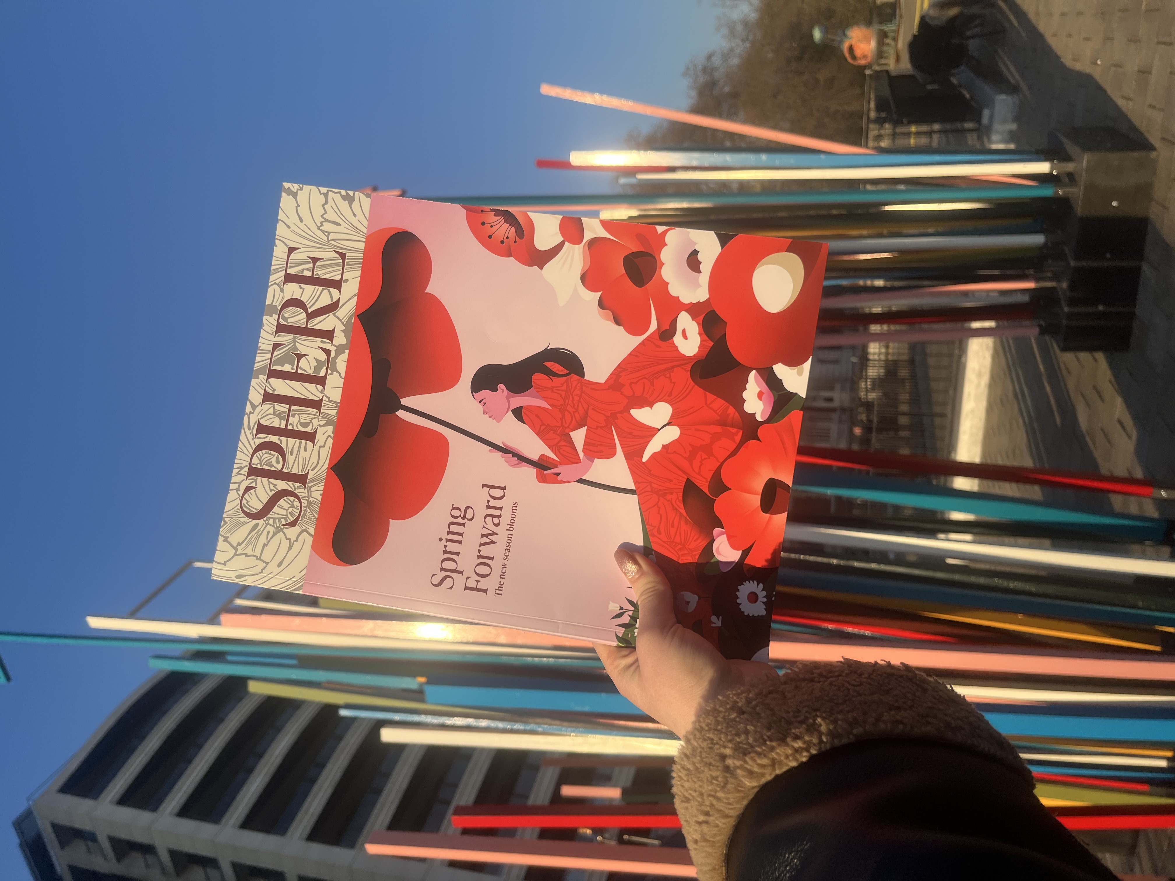 The SPHERE Spring Issue 2025 in front of a colourful sculpture in Temple's art garden.