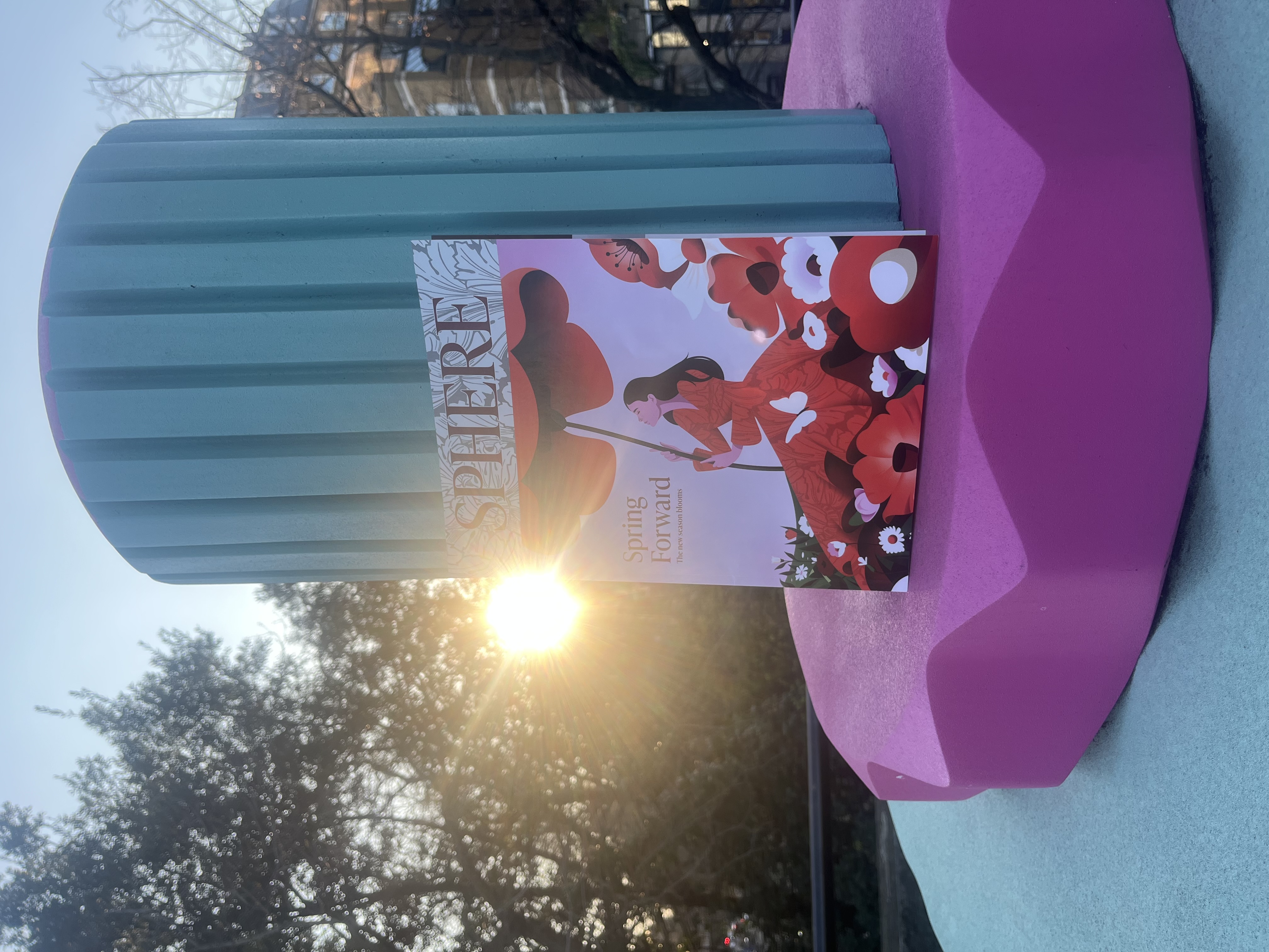 The SPHERE Spring Issue 2025 leaning against colourful sculpture in Temple's art garden.