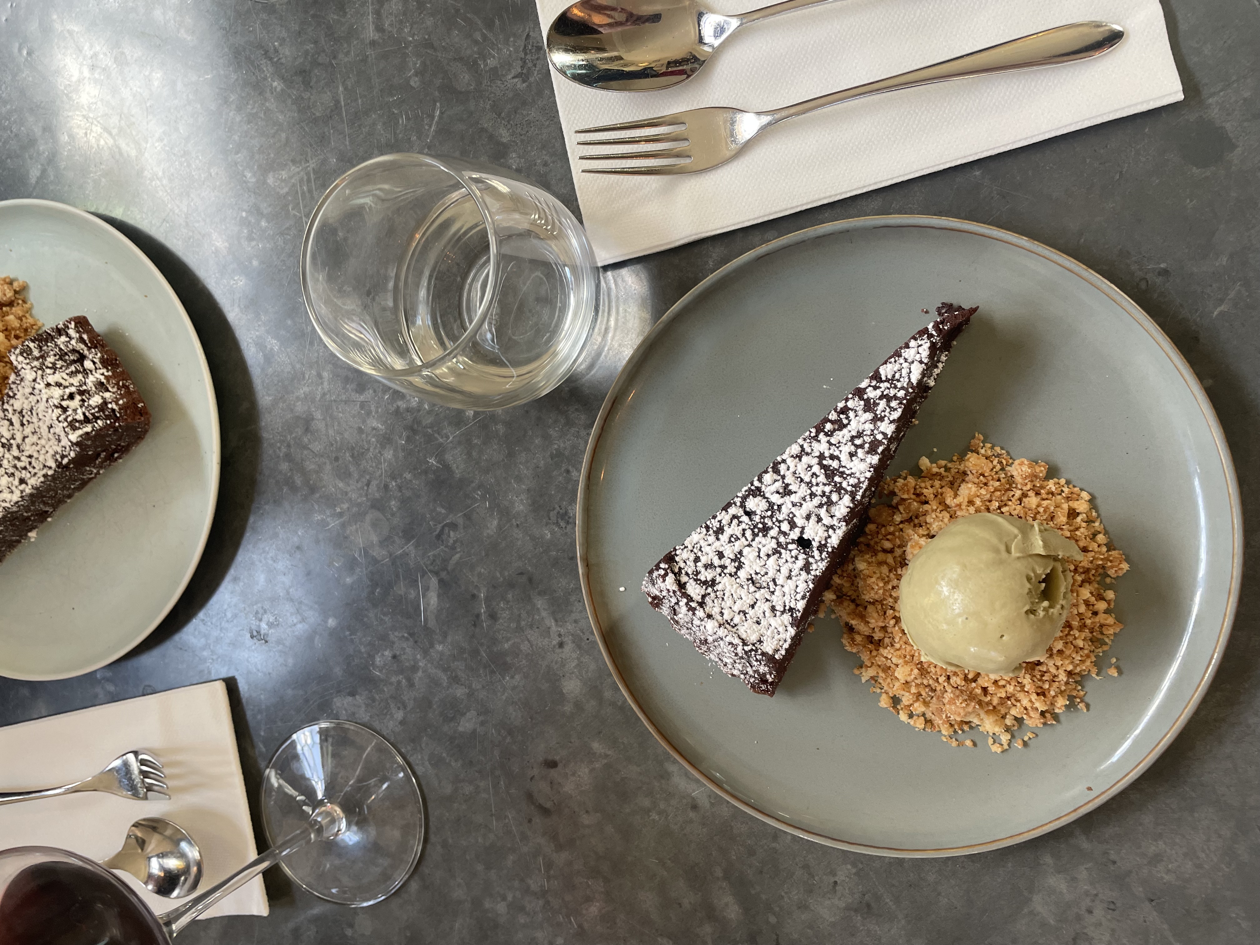 Luxury 24 Hours in Marylebone, a plate of chocolate cake dusted with powdered sugar, served with a scoop of ice cream.