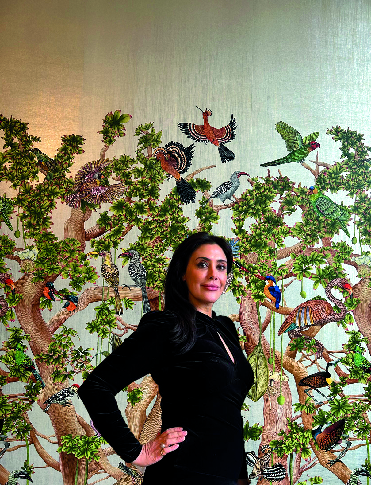 150 Years Cole & Son wallpaper - Marie Karlsson Creative and Managing Director of Cole & Son standing in front of the 'Baobab Tree' wallpaper wearing black.