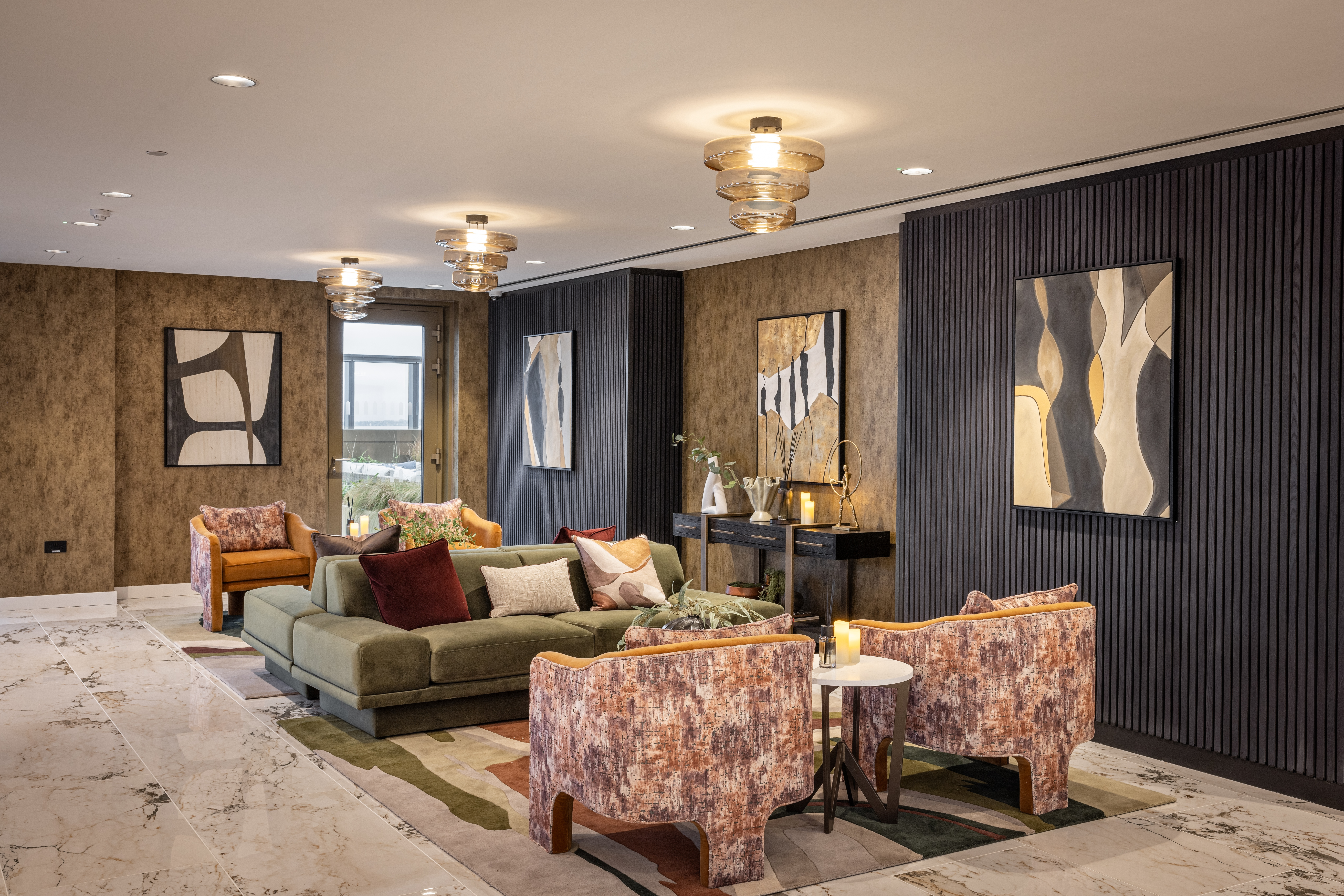 Property of the Week One Thames Quay - A stylish sky lounge at One Thames Quay, featuring plush seating, modern artwork, and elegant lighting with marble flooring and textured walls.