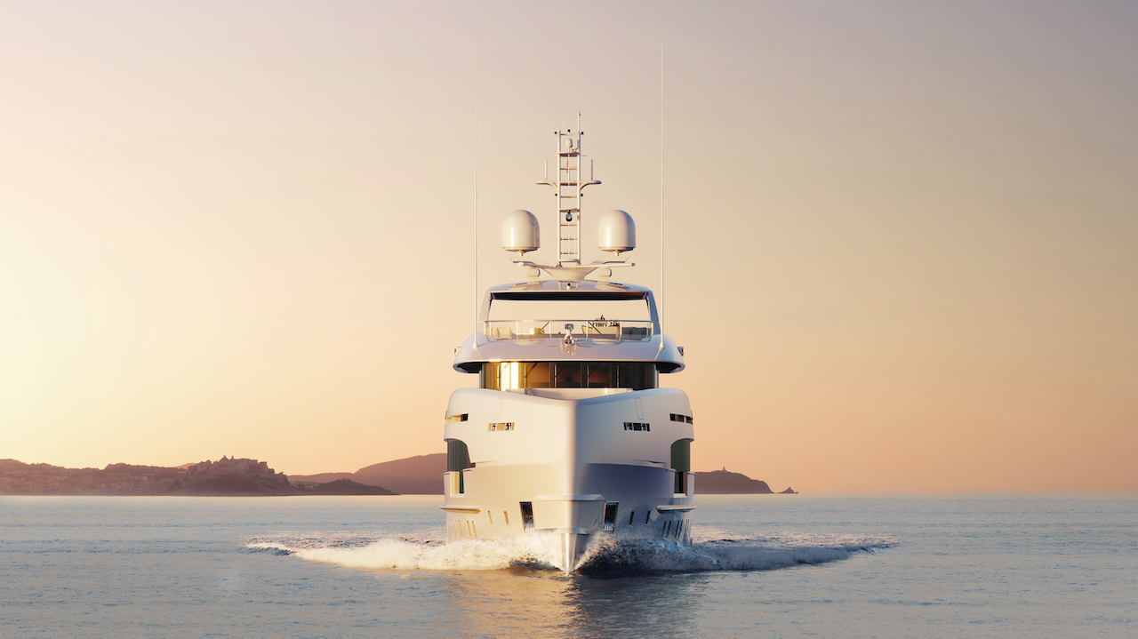 The Project Orion Yacht facing front-on as it glides through water at sunset.