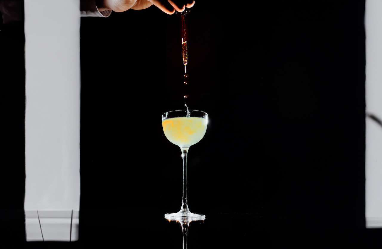 BAR45 Simplicity Cocktail - a liquid dropper dripping saffron oil into the parmatini cocktail.