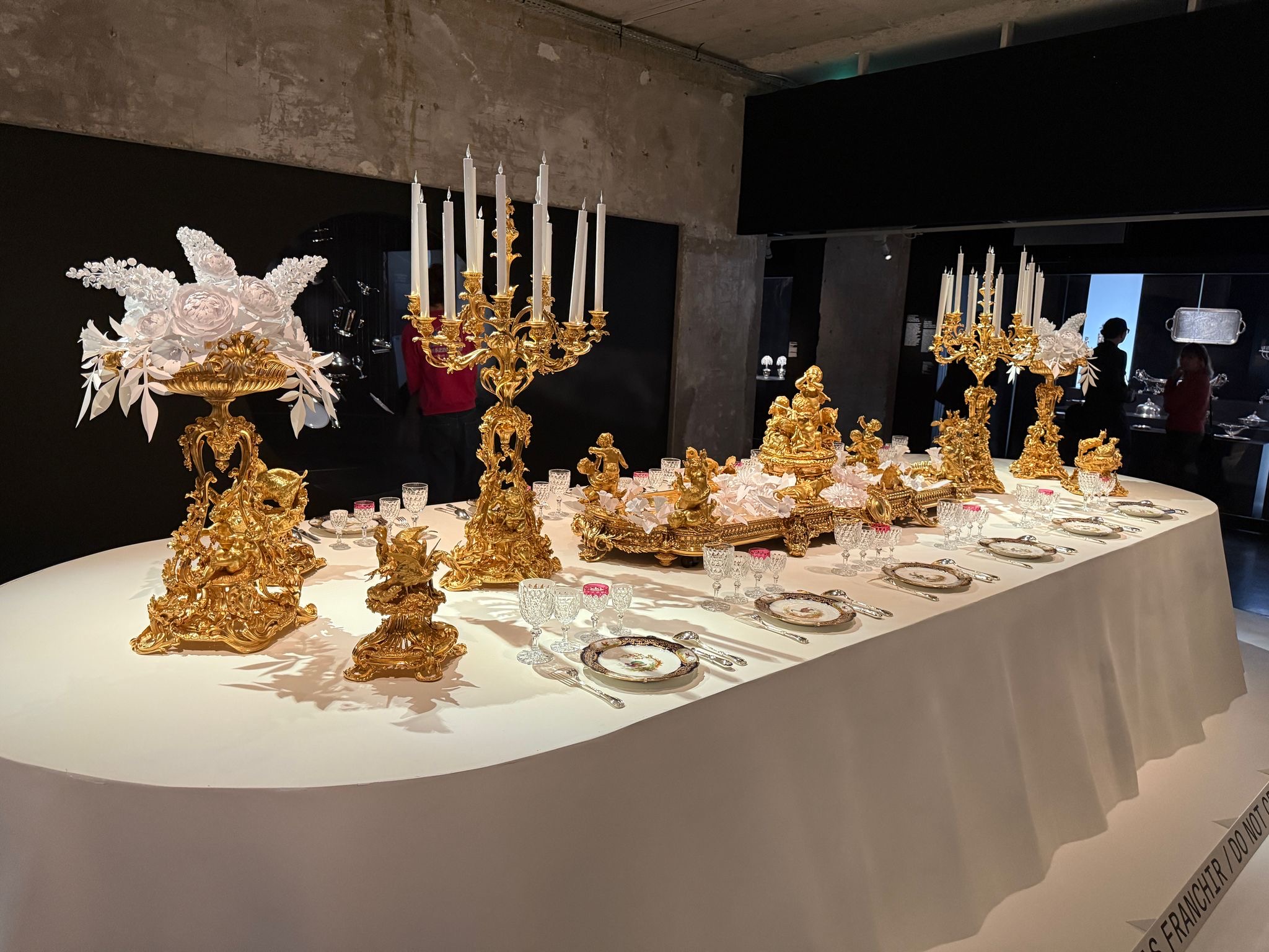An opulent dining table display in the Christofle Paris archive exhibition 2025.