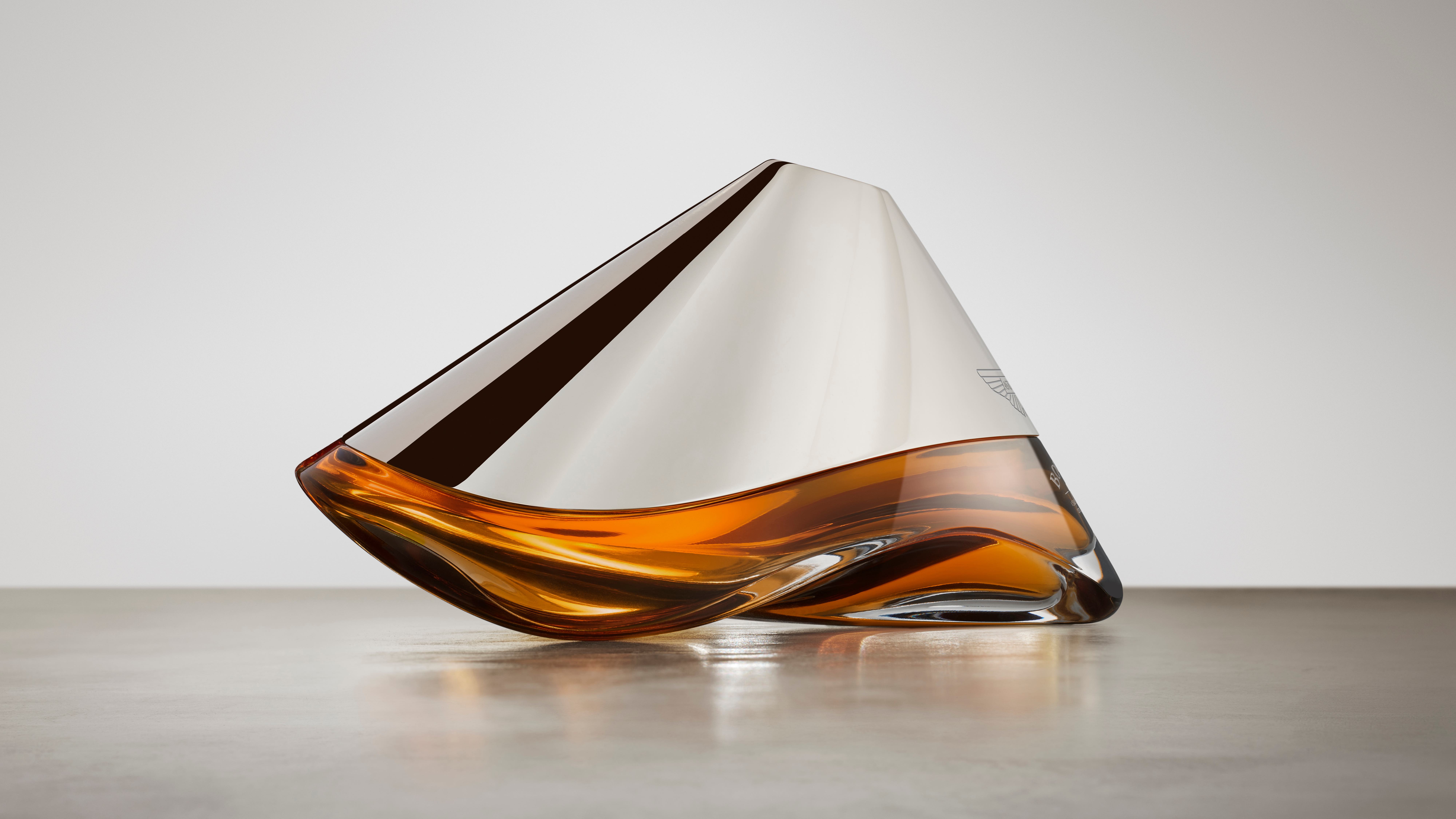 The curved decanter of Bowmore ARC-54 from the side as designed with Aston Martin.