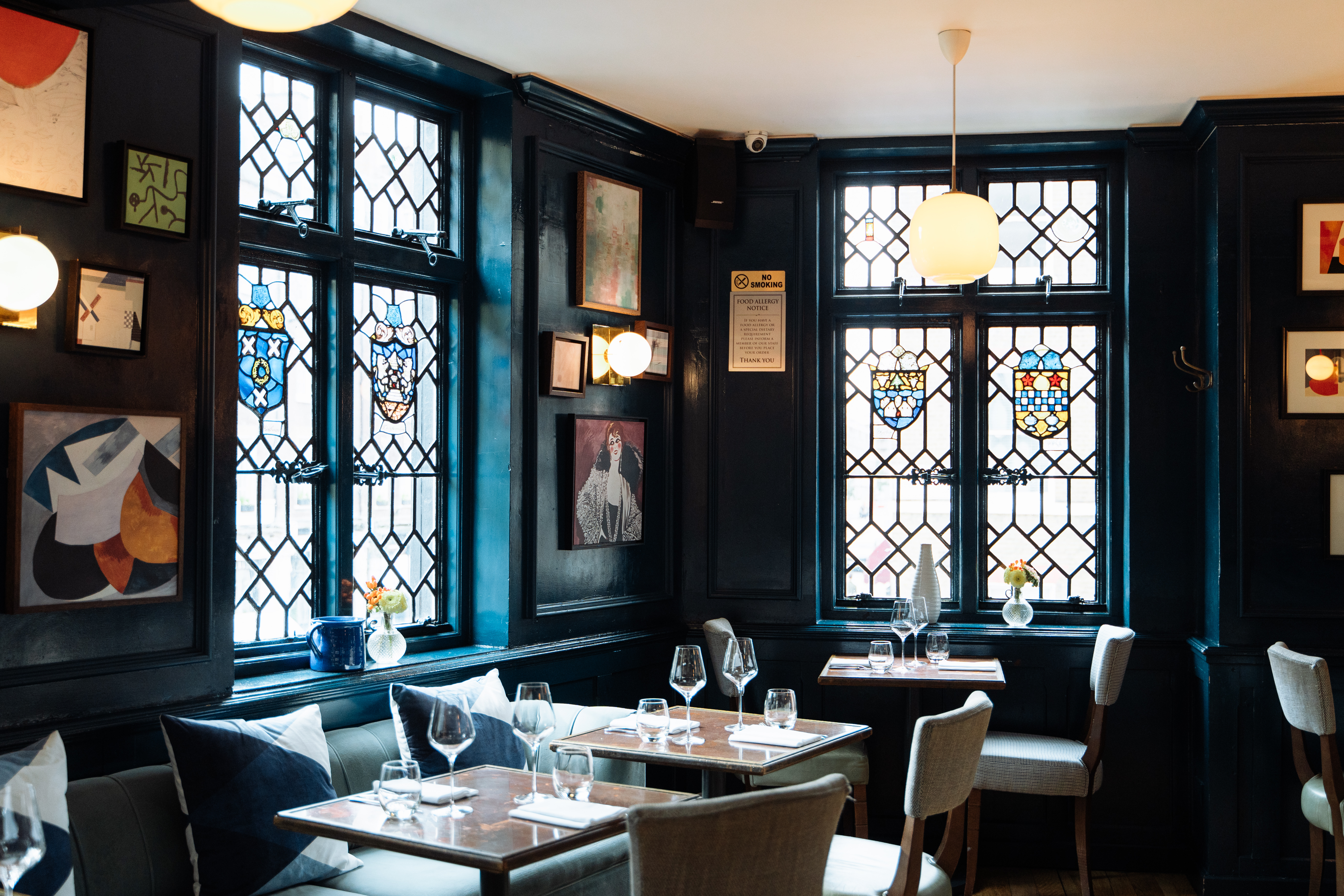 The cozy interior of Clarette with stained glass windows and contemporary art.