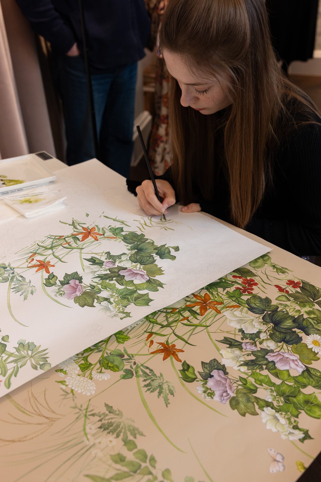 Niamh Wright painting a wallpaper panel during the Cole & Son Jubilee Place Salon.