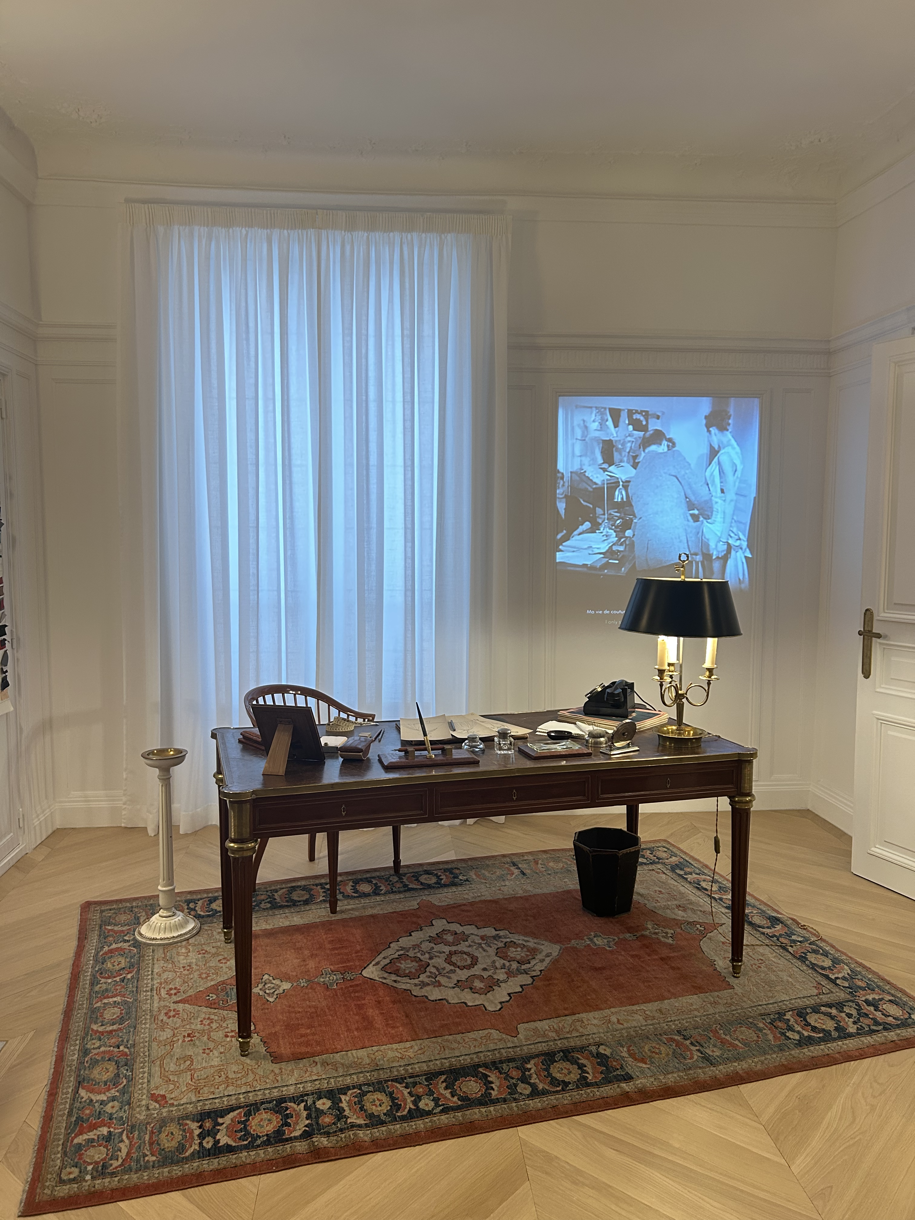 A recreation of Christian Dior's office at 30 Avenue Montaigne with his desk and some of his belongings scattered on top at La Galerie Dior in Paris.