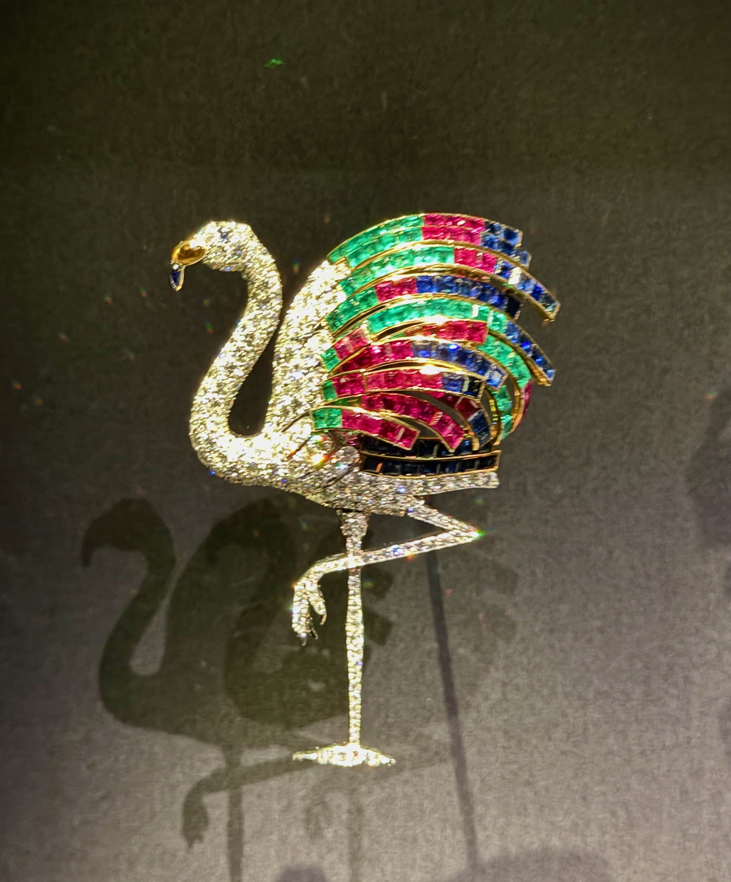 The Cartier Flamingo Brooch with green pink and purple jewels, on display at Cartier at the V&A.