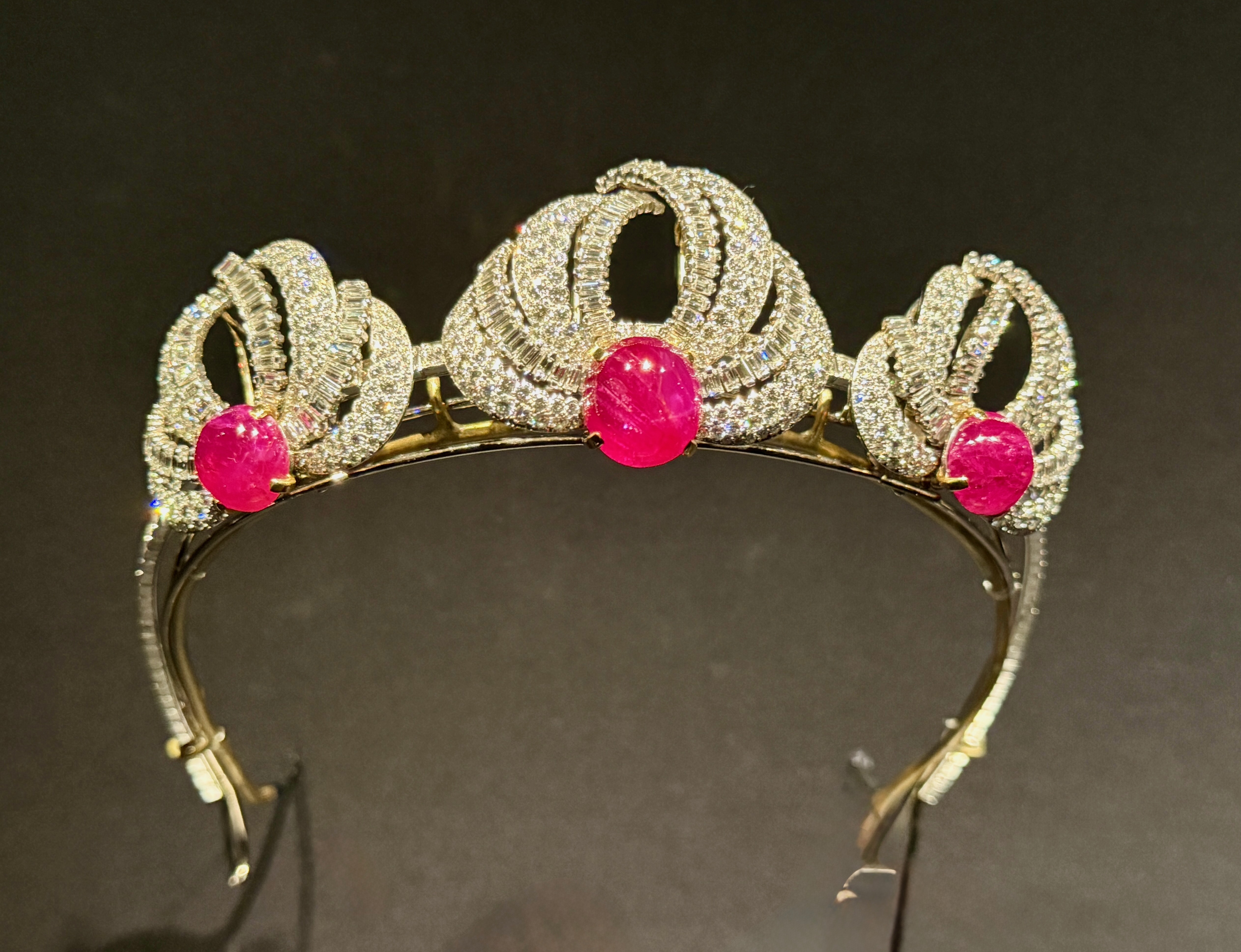 Cartier tiara with gold diamond-encrusted knots and three pink gemstones, on display at the V&A.