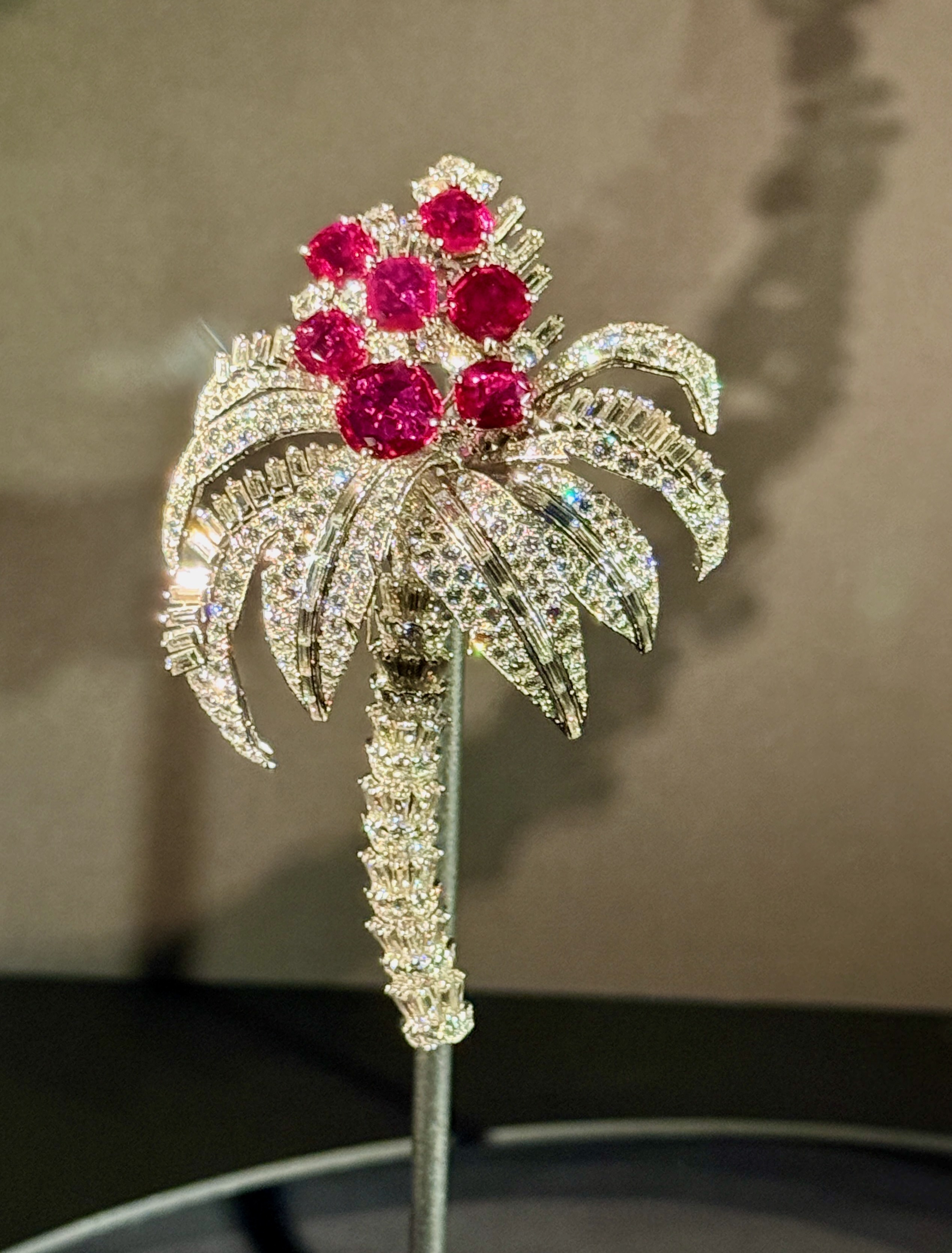A palm tree clip brooch by Cartier with rubies and diamonds on display at Cartier V&A.