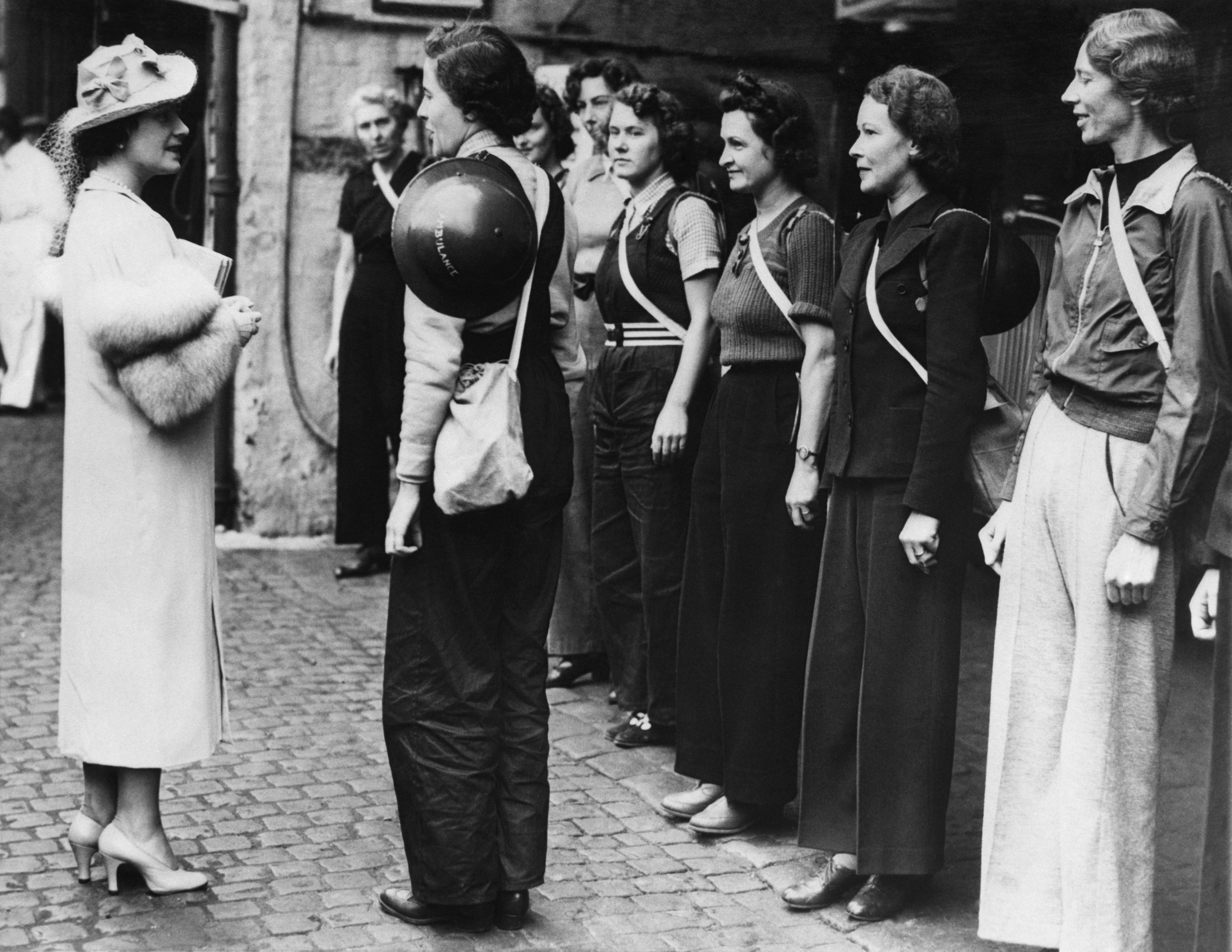 An image of the queen speaking to female London Ambulance garage volunteers in 1939.