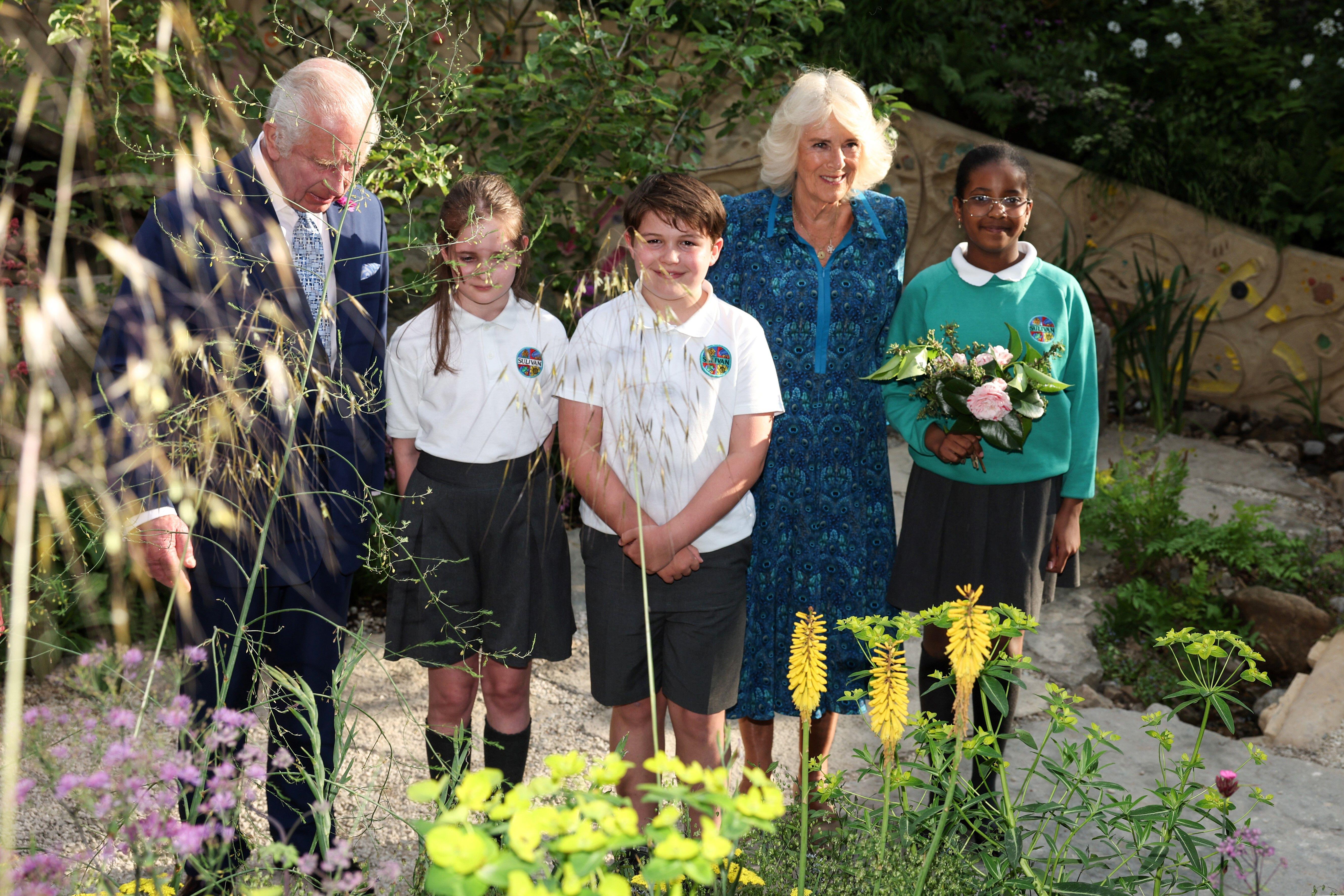 The King and Queen with schoolchildren in the No Adults Allowed Garden at the Chelsea Flower Show.