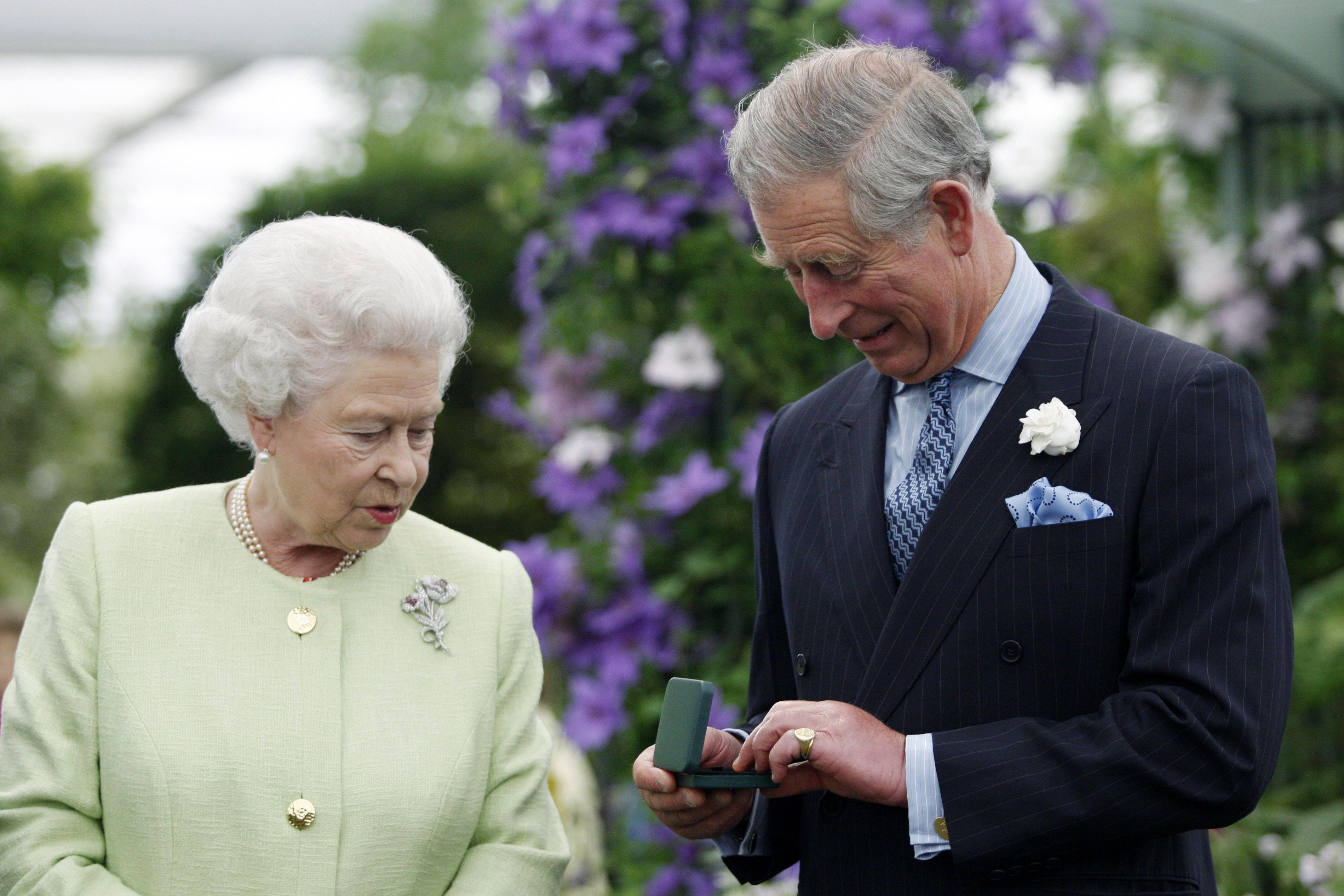 An image of Queen Elizabeth II with the then-Prince of Wales at Chelsea Flower Show.