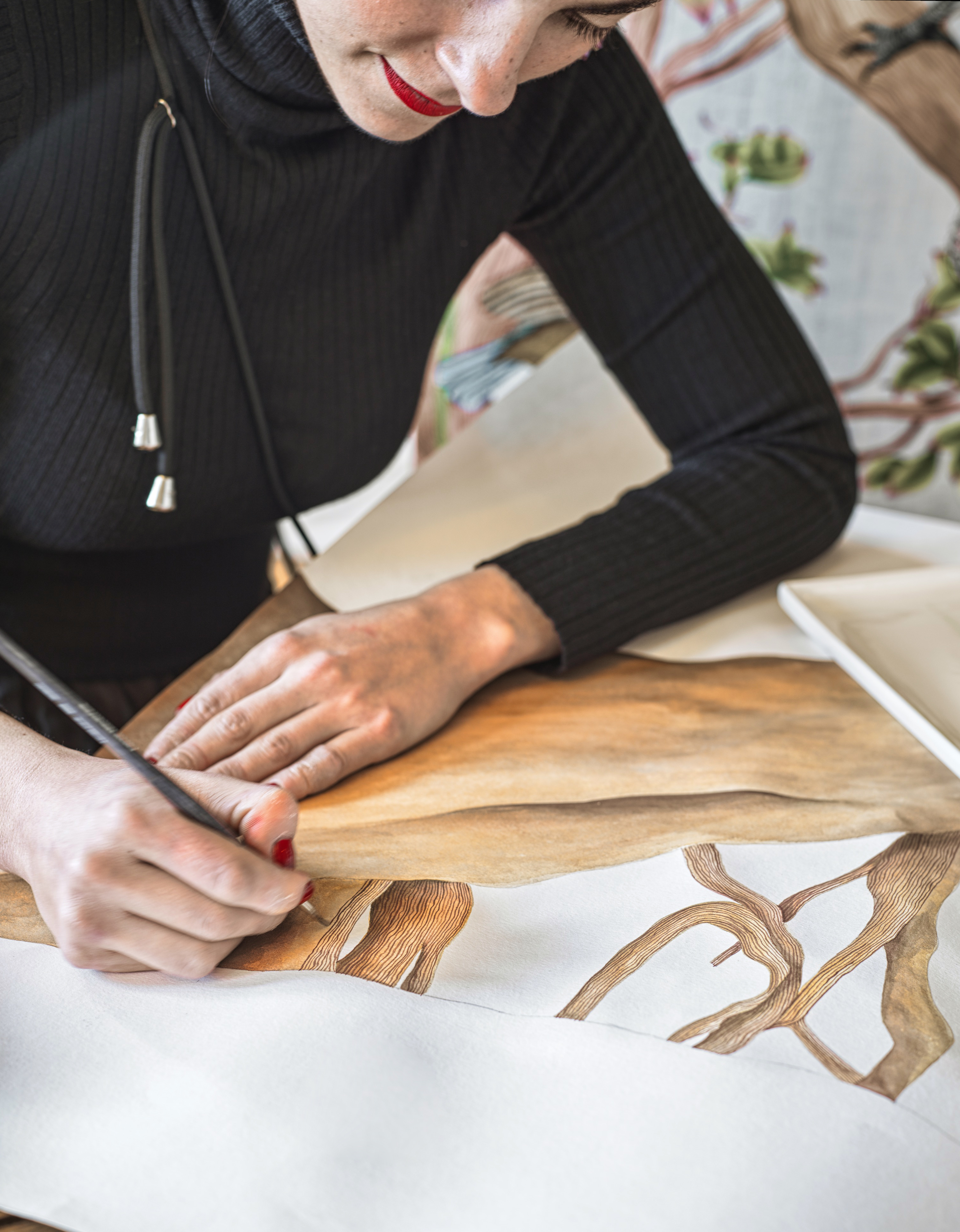 Cole & Son Royal Warrant - A member of the team hand-painting wallpaper.