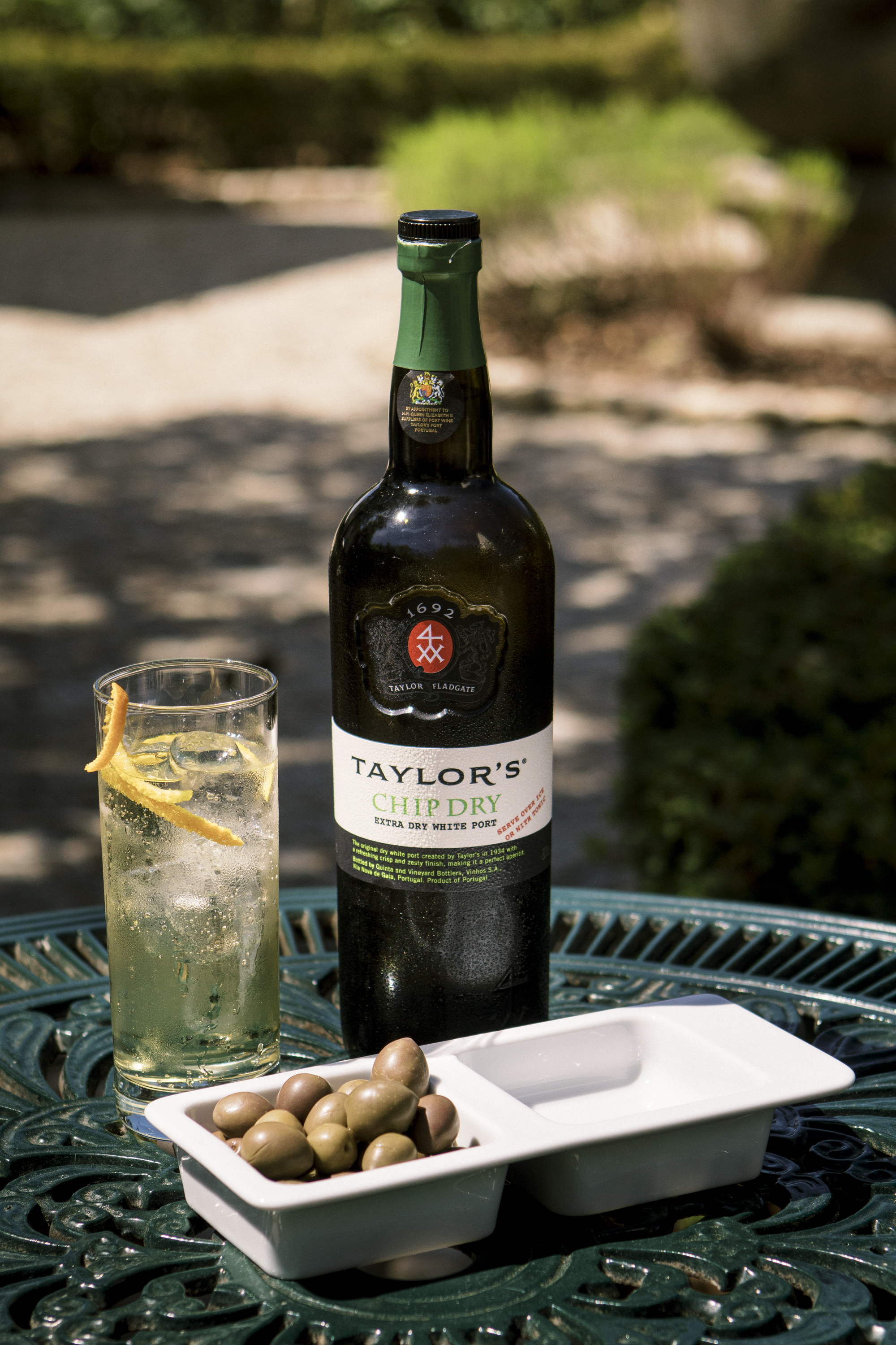 A bottle of Taylor's Chip Dry Extra Dry White Port, served with tonic and olives.