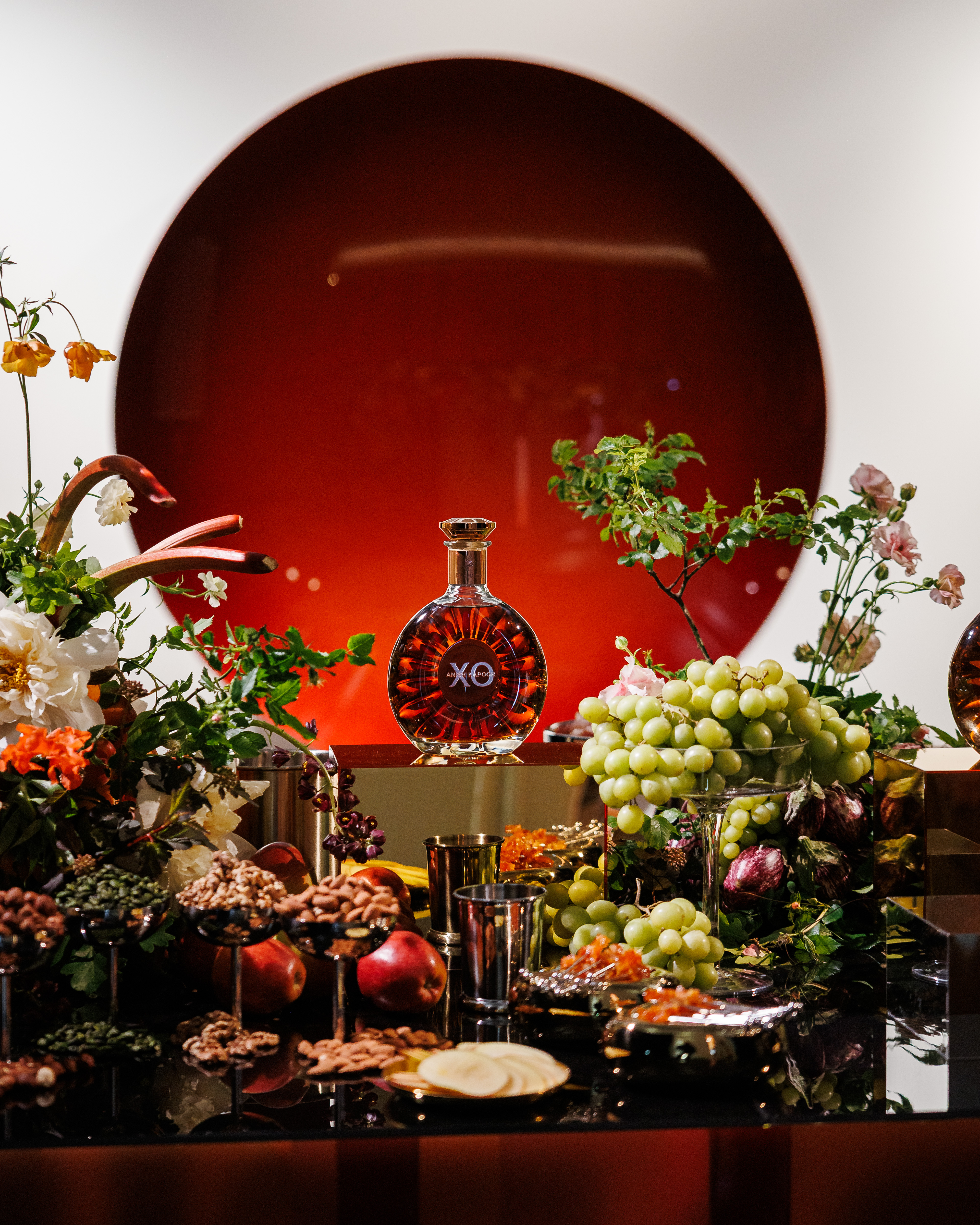 Rémy Martin and Anish Kapoor XO Cognac in front of Kapoor's artwork.