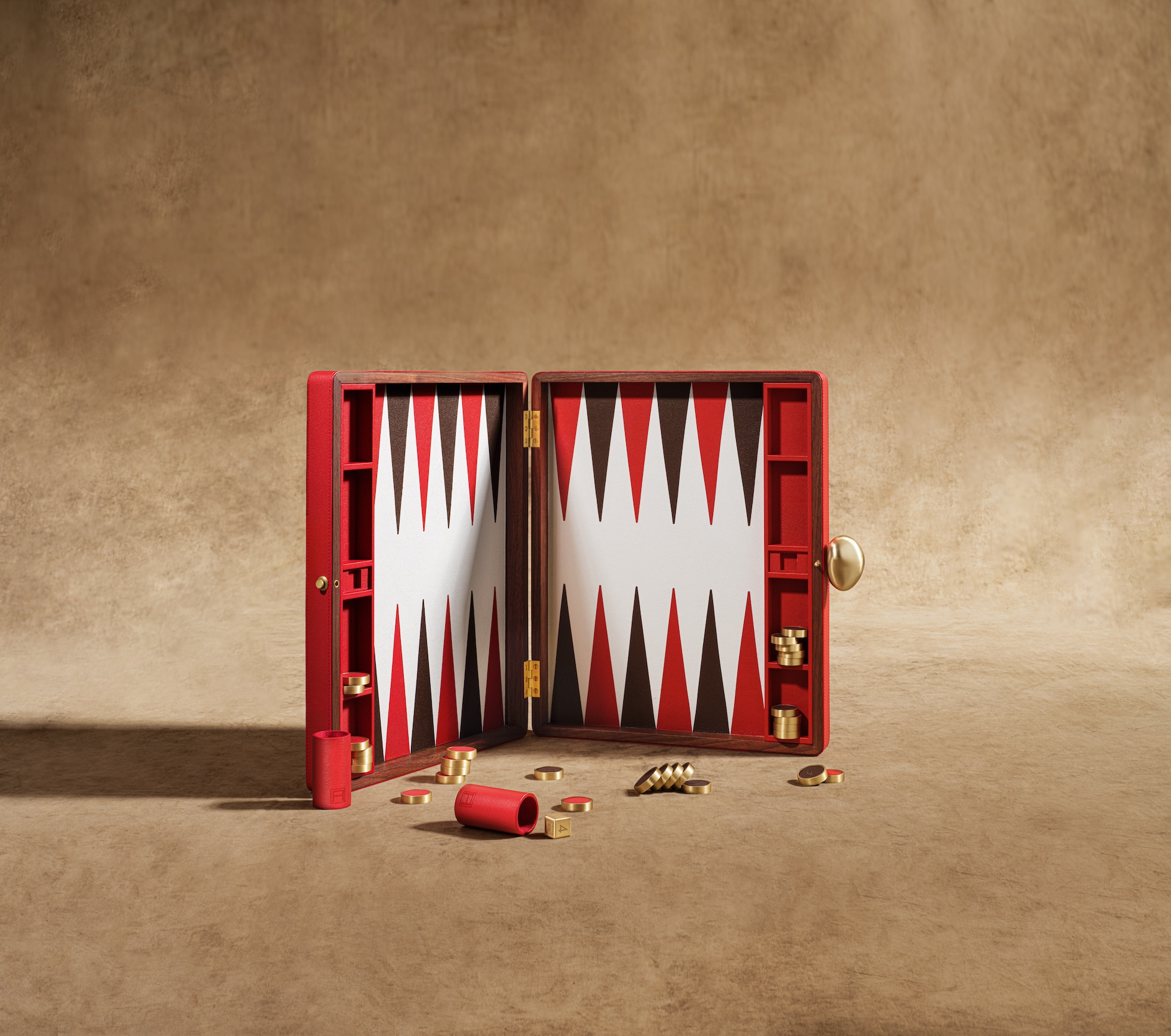 An open Backgammon Set with a black and red design as part of The Library by Maison Assouline.