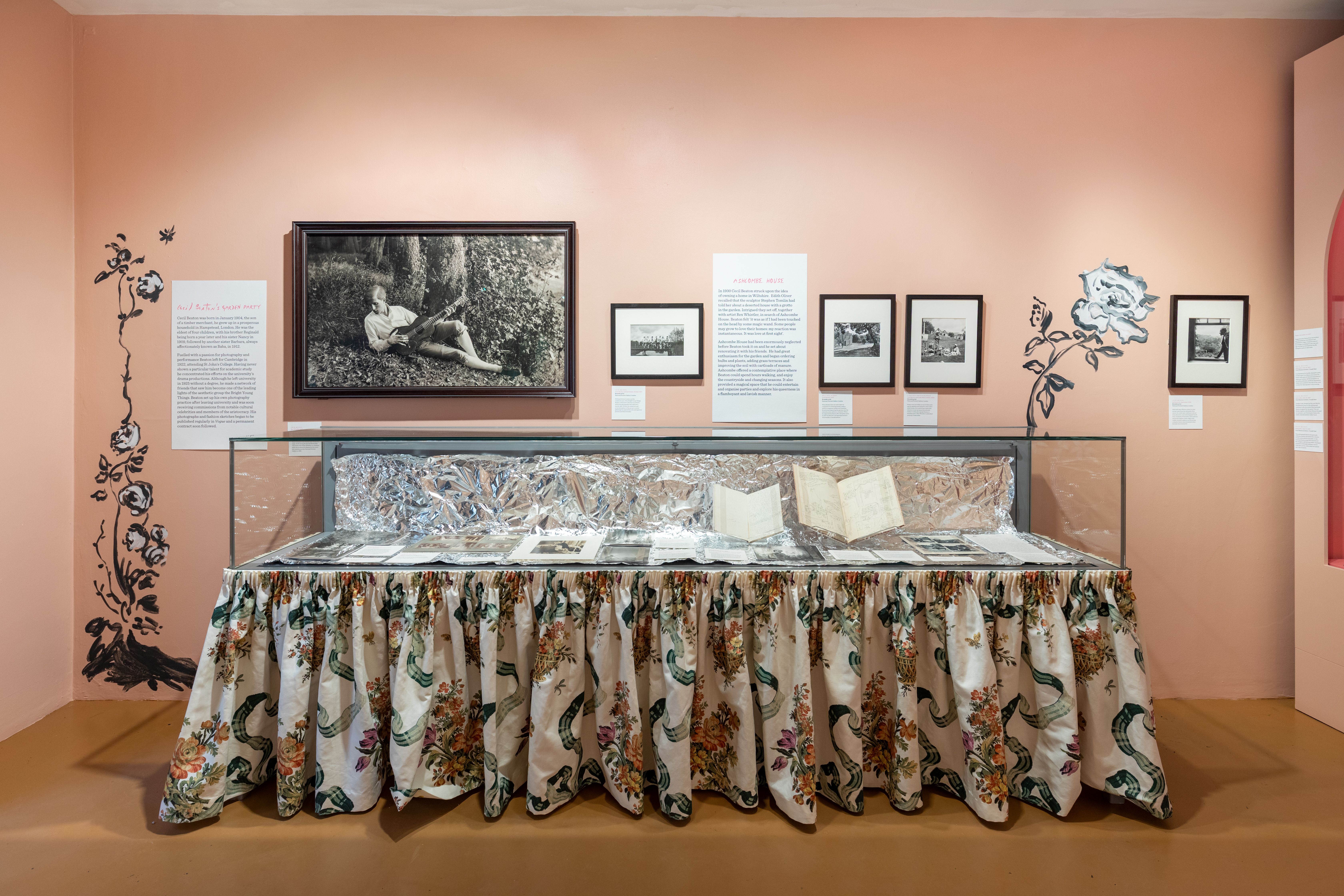 A glass display case at the entrance to Cecil Beaton's Garden Party