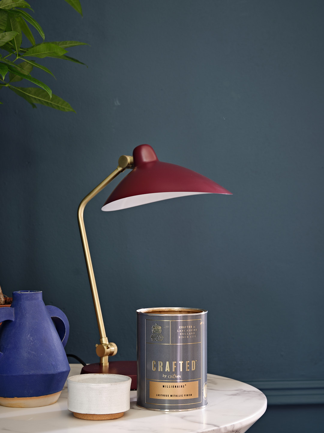 An open tin of Crafted by Crown Paints in the shade Millionaire.