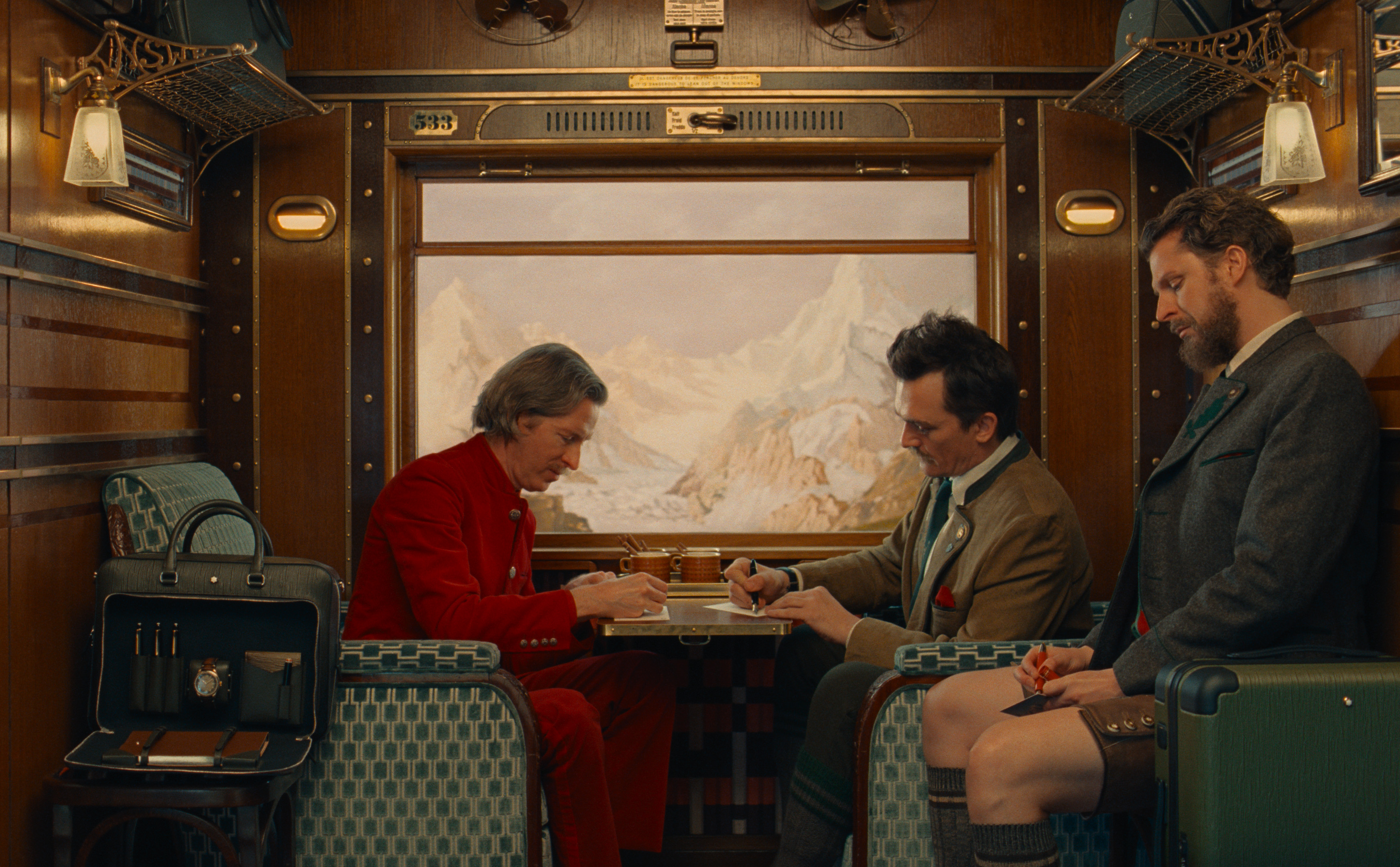 Anderson, Friend and Cera take a seat in a suspended train carriage during Wes Anderson's campaign film for Montblanc.