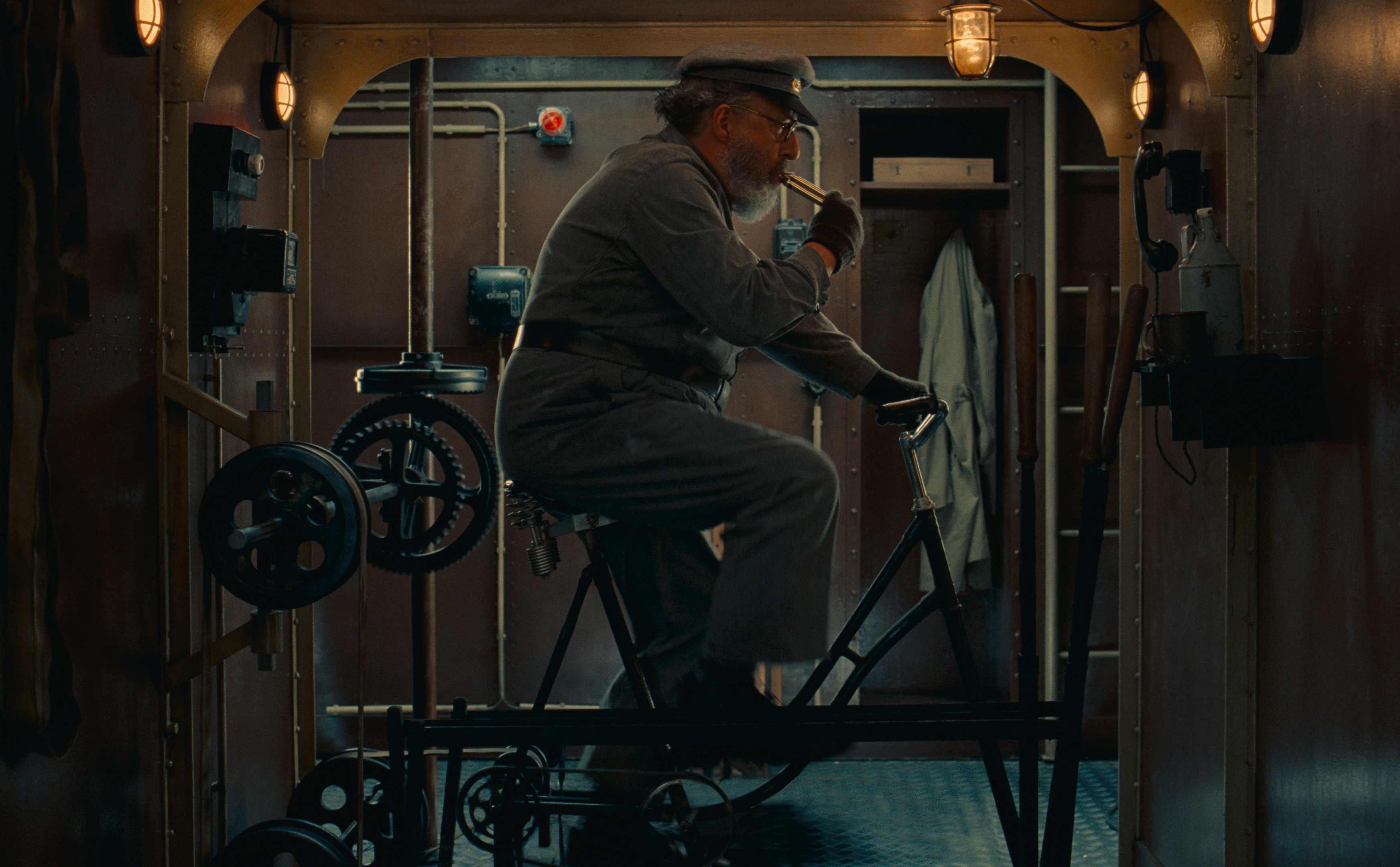 A train driver sits on a bike to direct the pedal-powered train carriage in Wes Anderson's short film for Montblanc.
