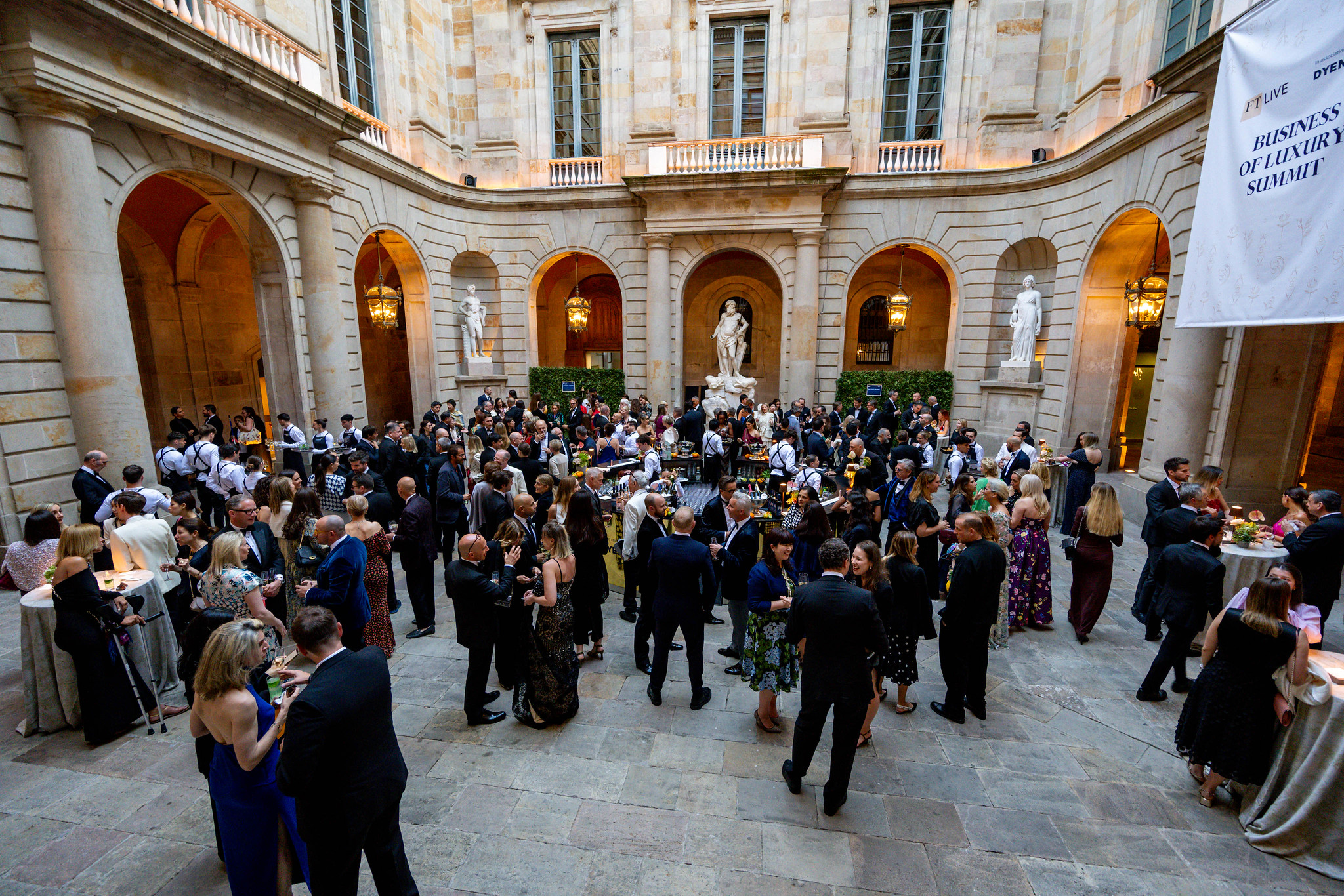 Groups of professionals networking at the FT Business of Luxury Summit 2025.
