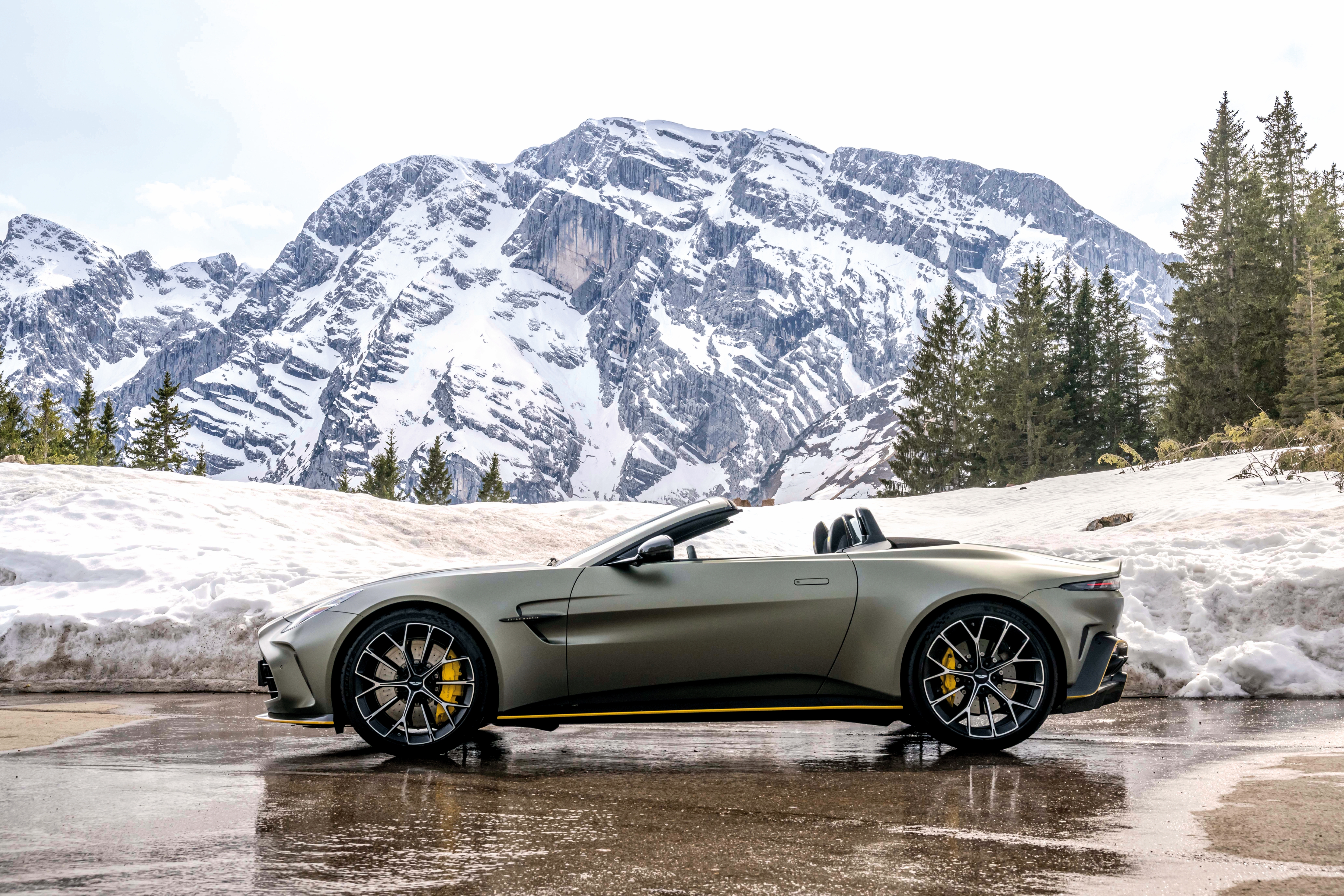 The Aston Martin Vantage Roadster in front of Austrian Mountains.
