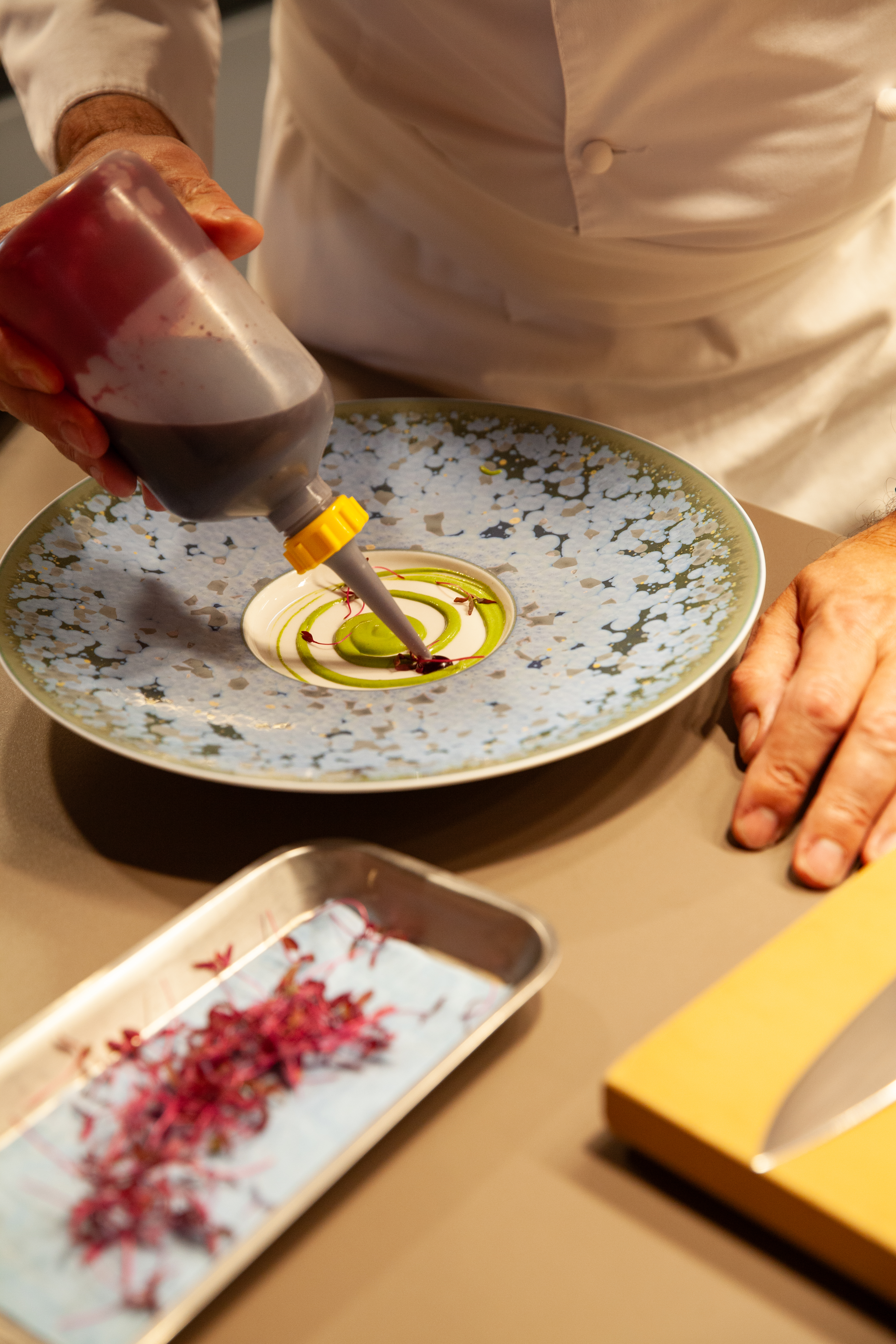 Yannick Alléno plating up a dish at Pavyllon.