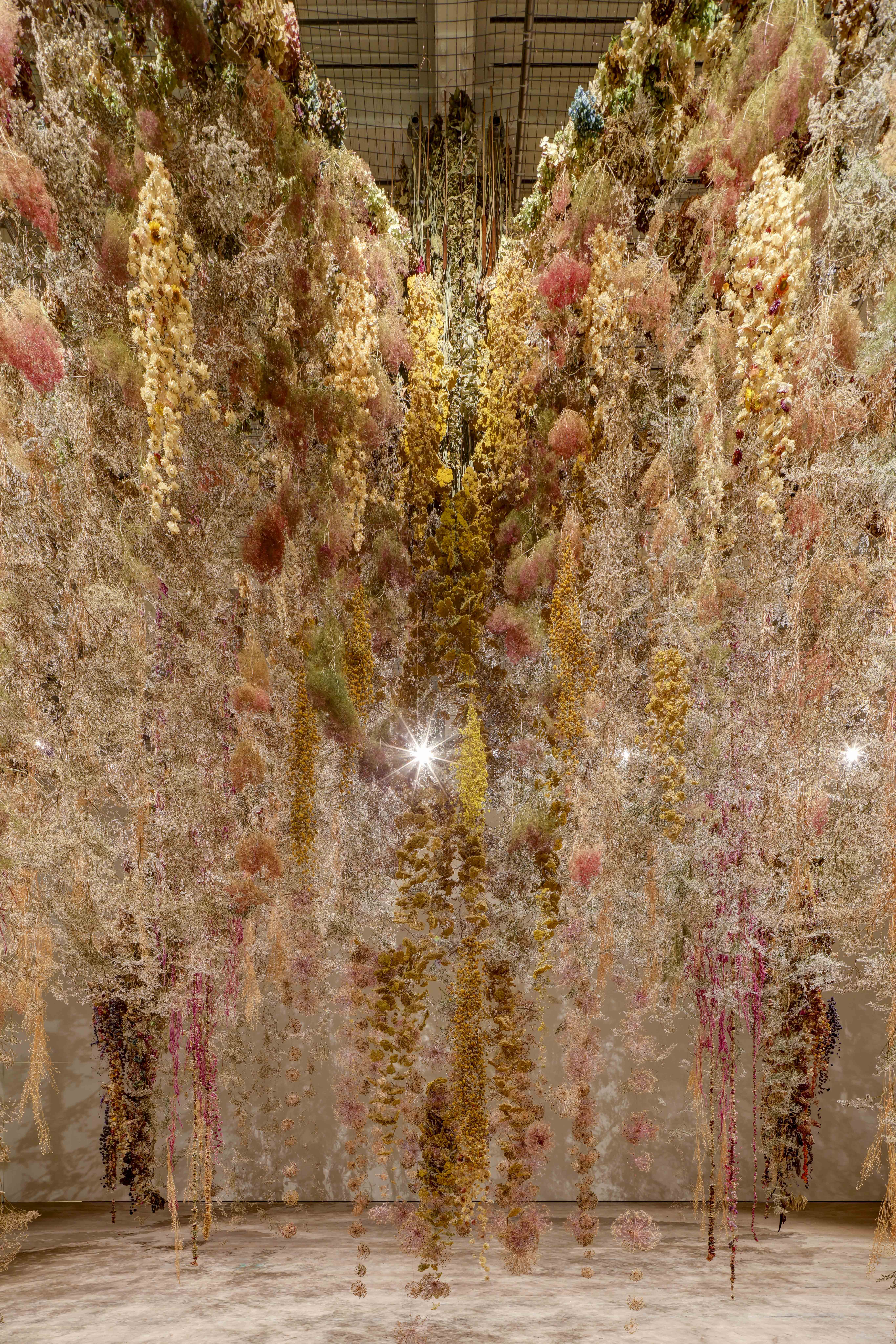 Dried flowers droop from Saatchi Gallery's ceiling.