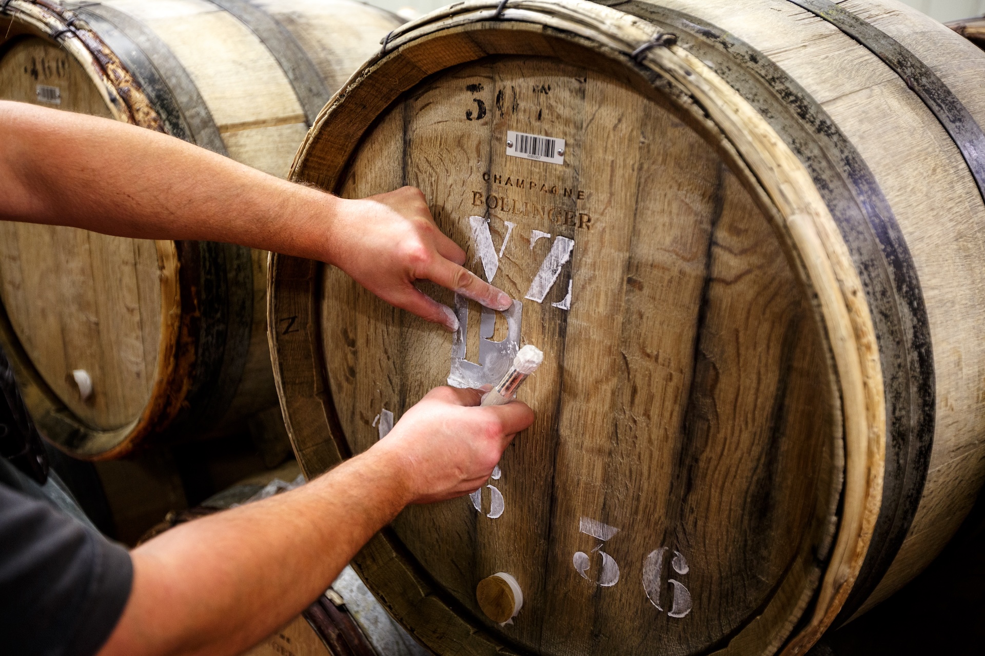 Champagne Bollinger oak barrels being painted.
