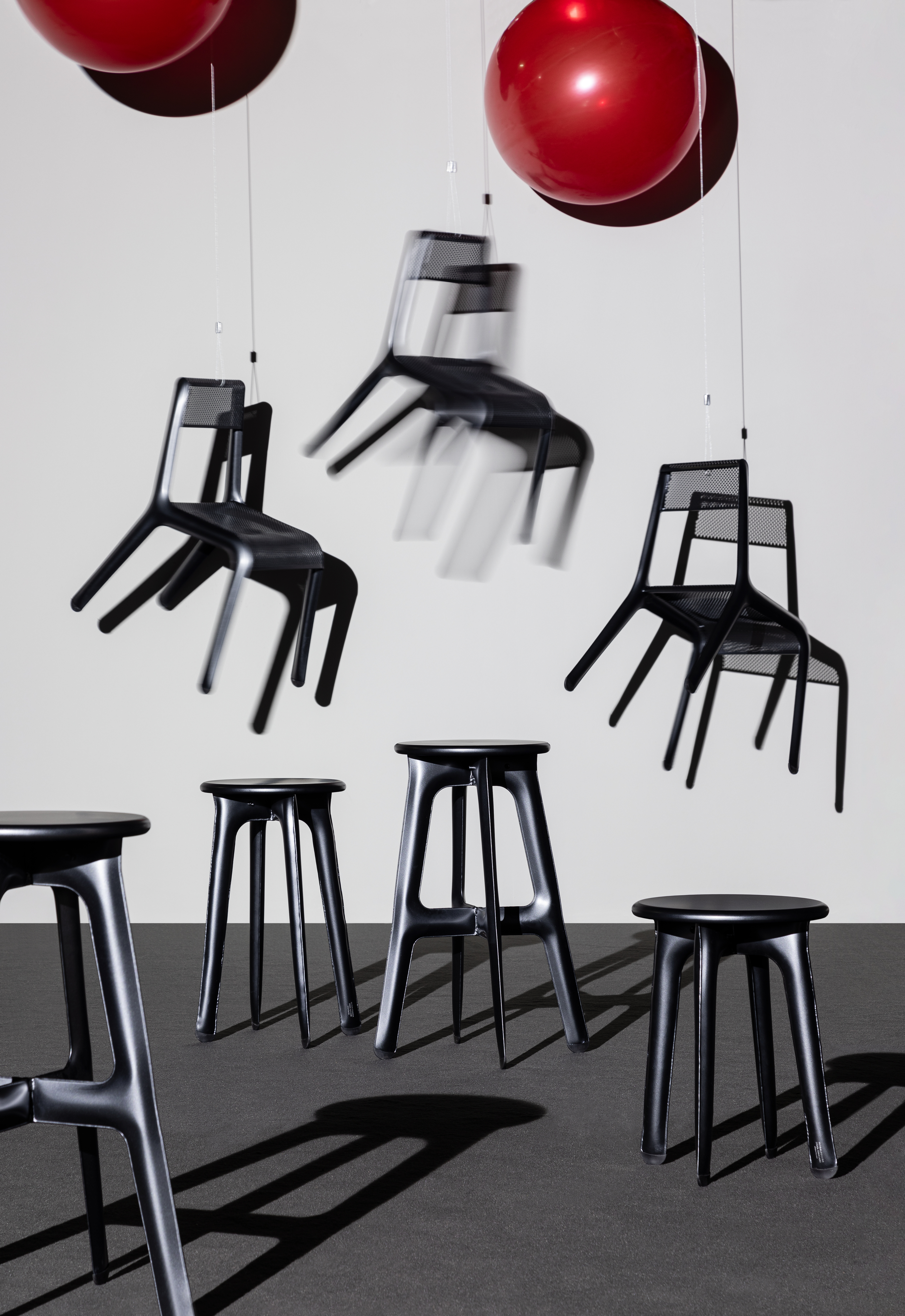 The Ultralegga chairs are so light that they drift away with the help of two large red balloons.