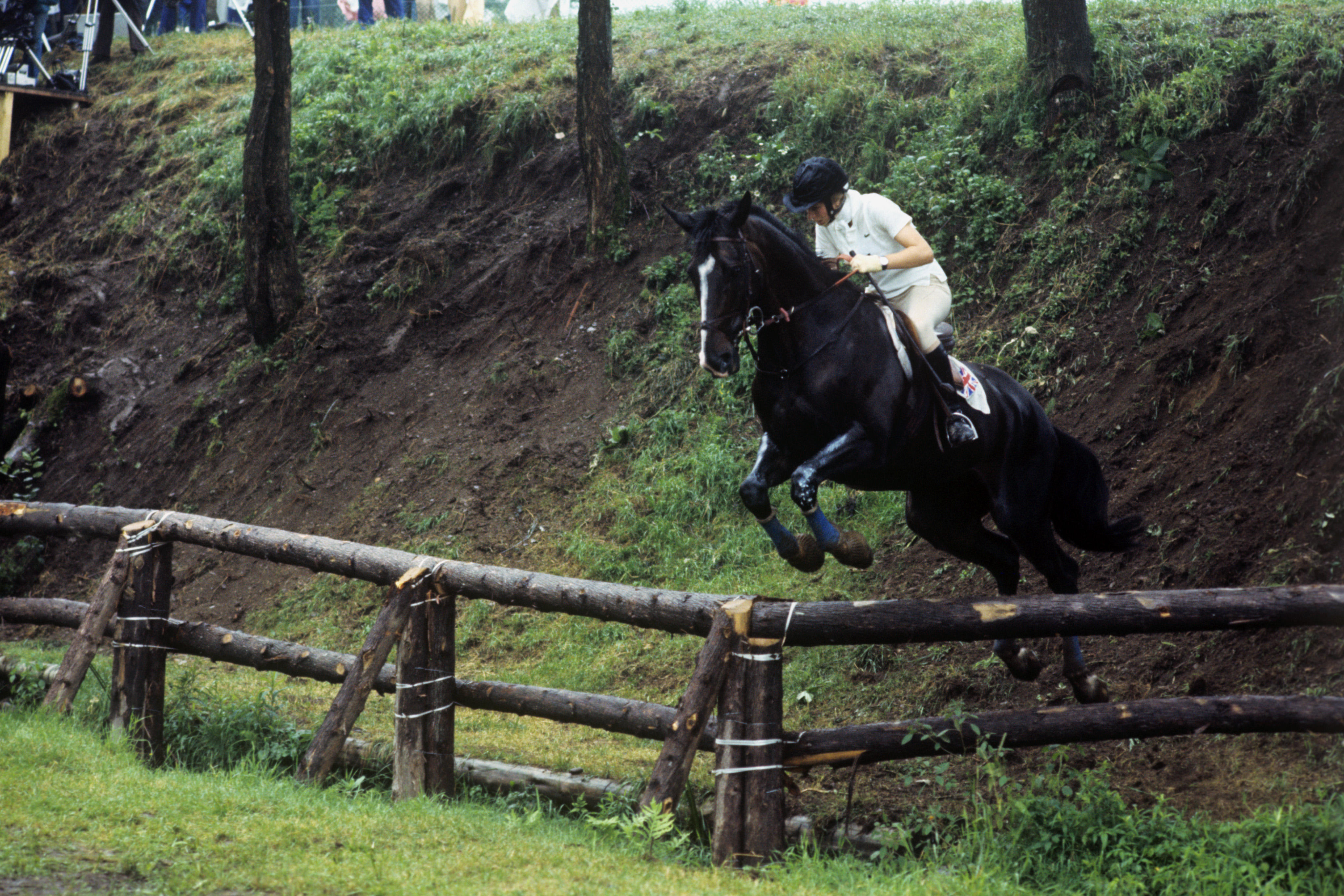 Princess Royal on her horse, jumping over fence.
