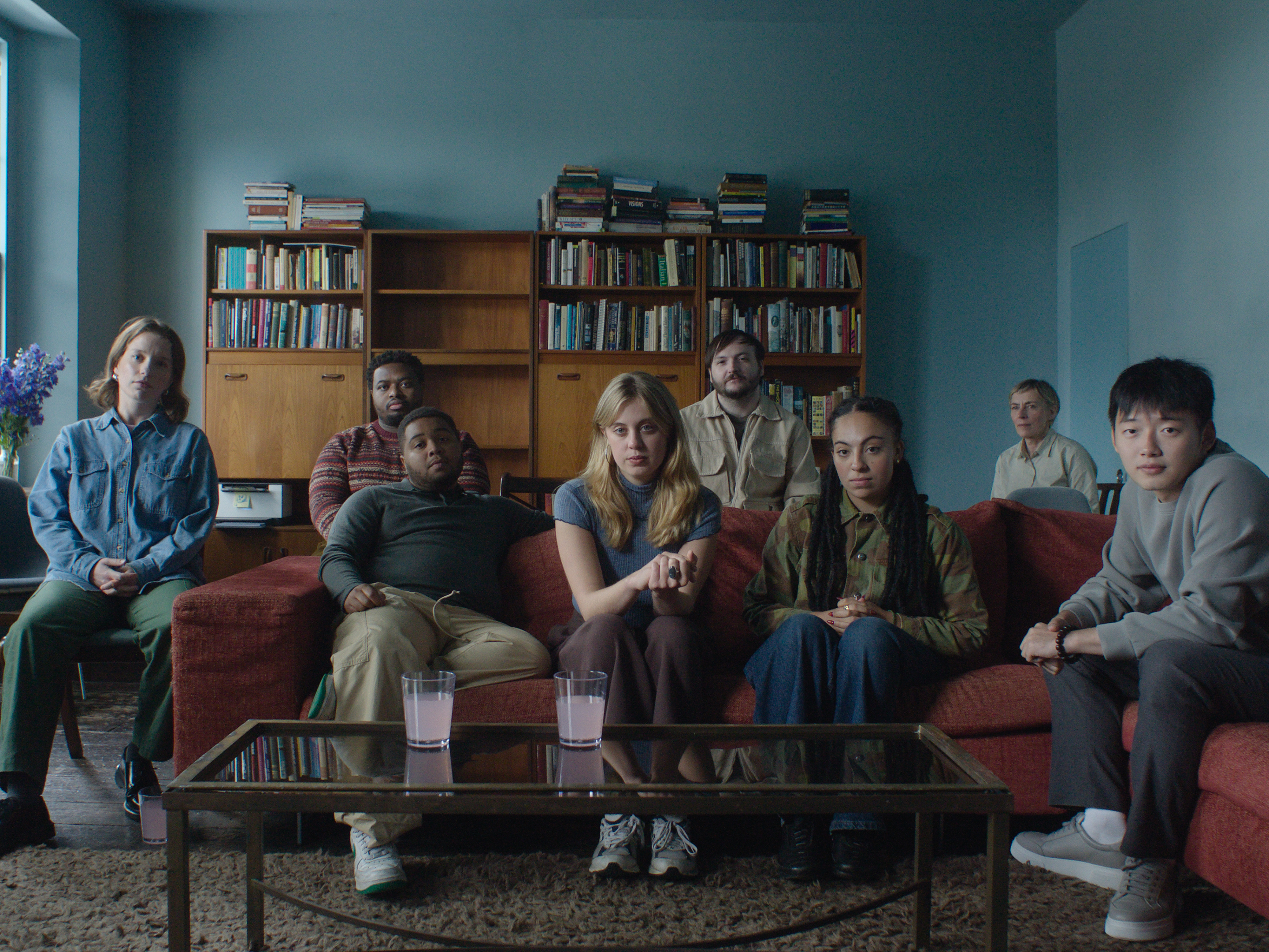 A group of young adults stare back at the viewer.