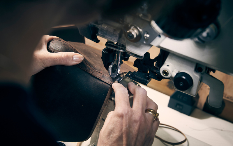 A craftsman stitching a Crockett and Jones shoe.