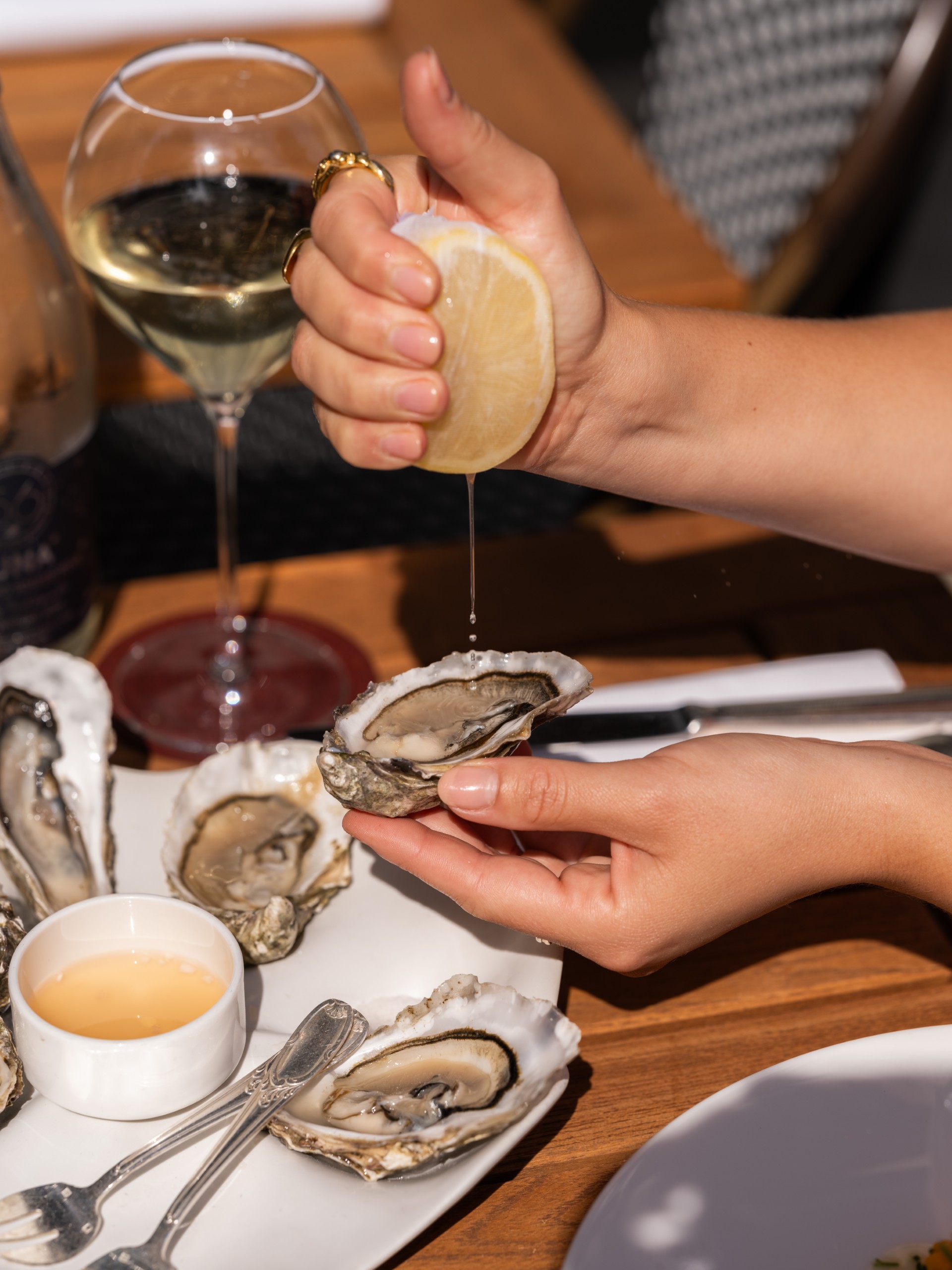 Oysters in London - squeezing lemon onto an oyster at Origin City.