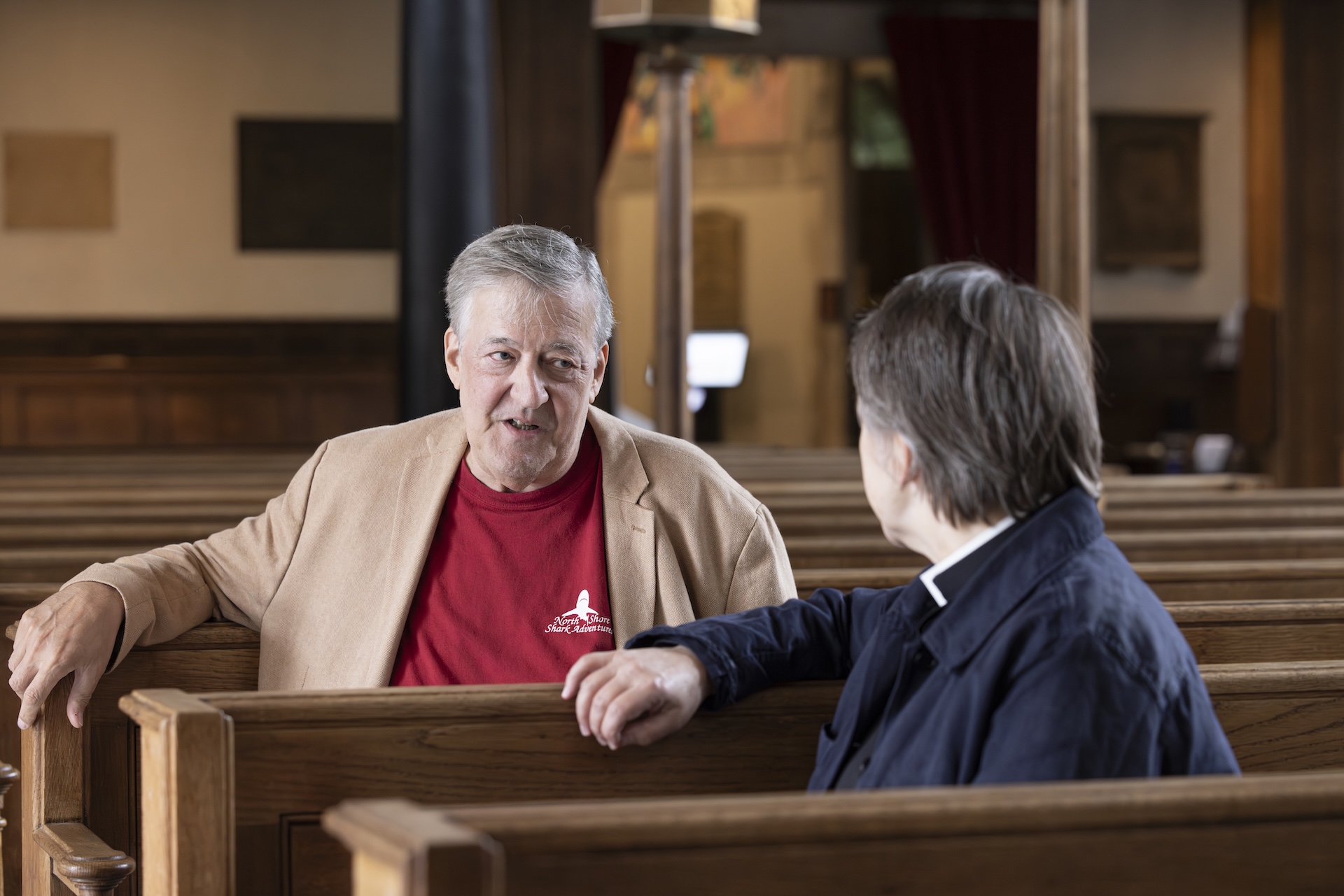 Stephen Fry and Lucy Winkett speaking in the pews of St James's Church Piccadilly.