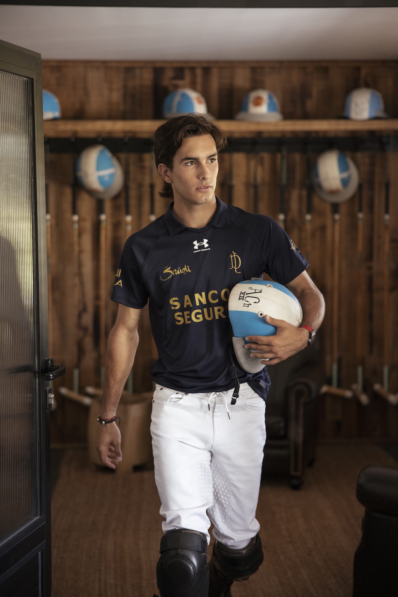 Poroto Cambiaso walking with his polo helmet.