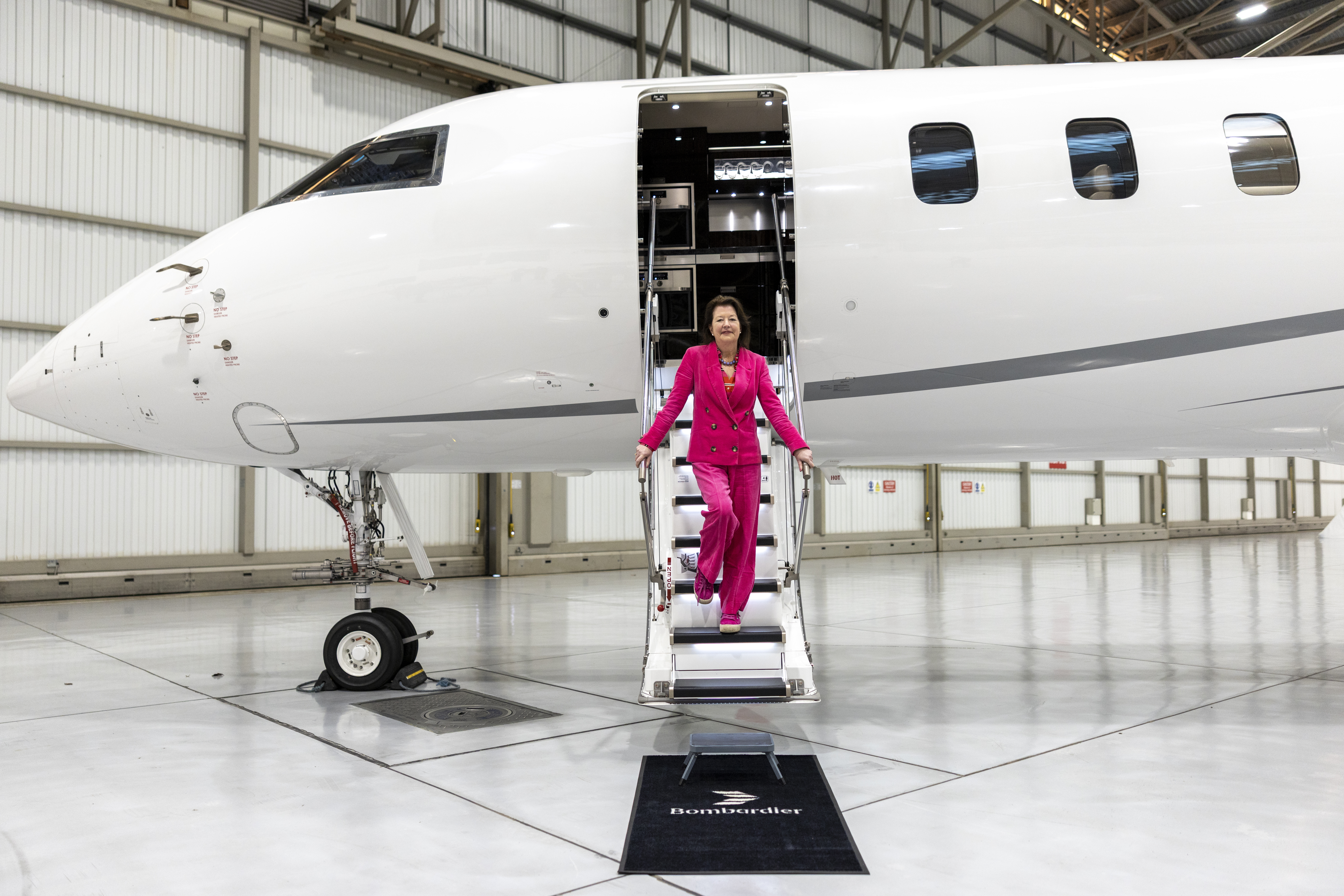 Lisa Barnard climbing the stairs of the fastest passenger jet. 