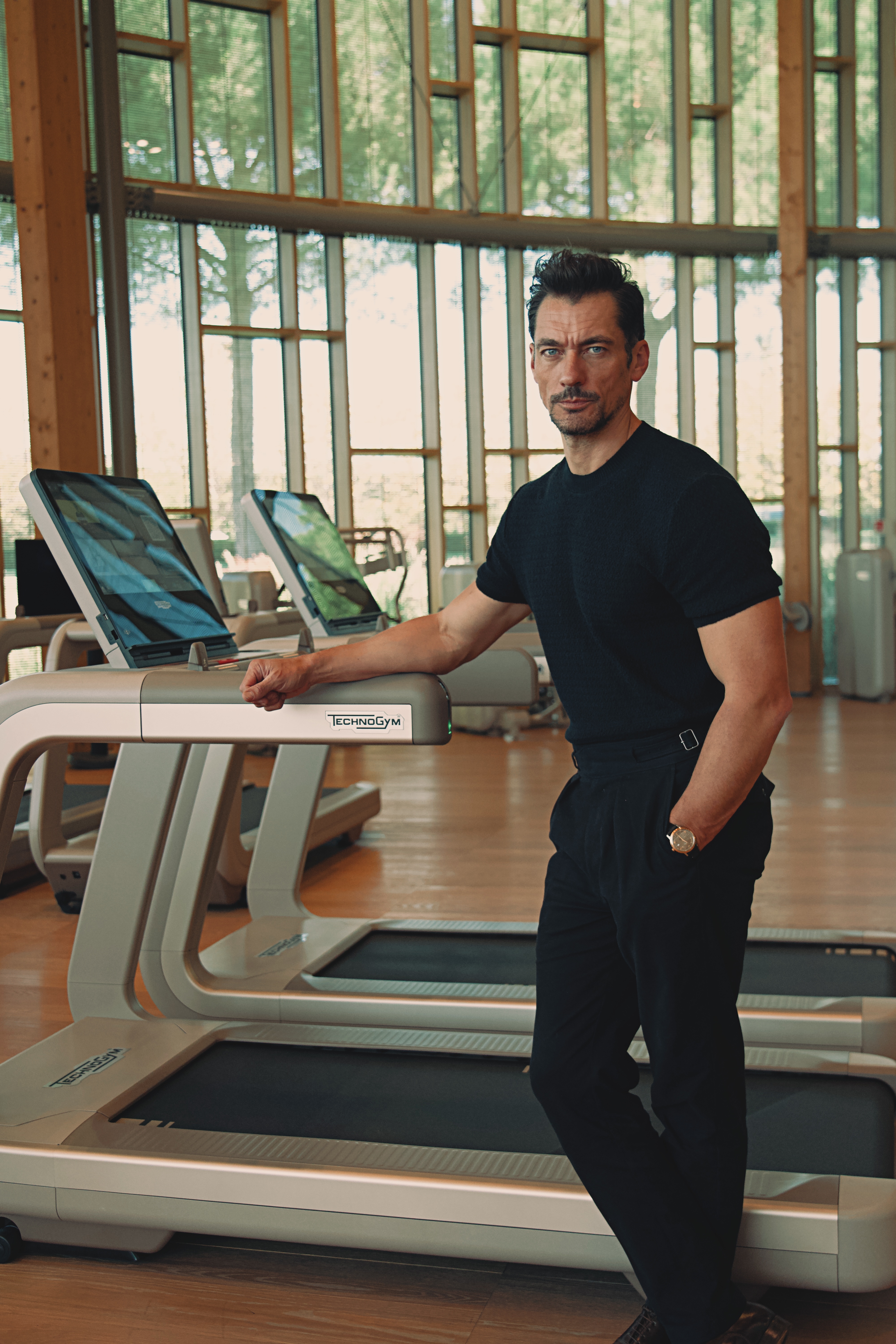 Supermodel David Gandy next to a Technogym treadmill.