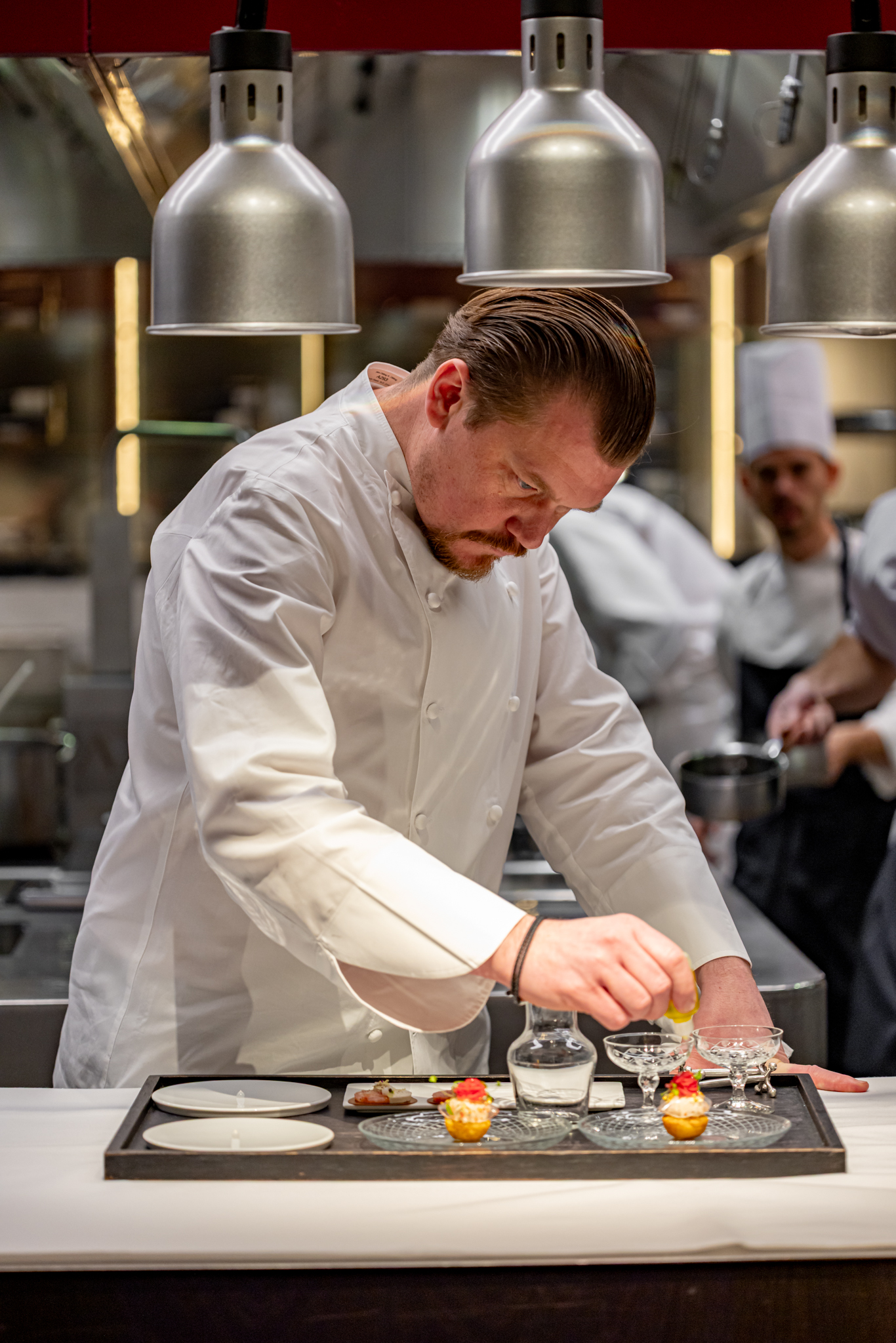 Chef Alex Dilling plating dishes. 