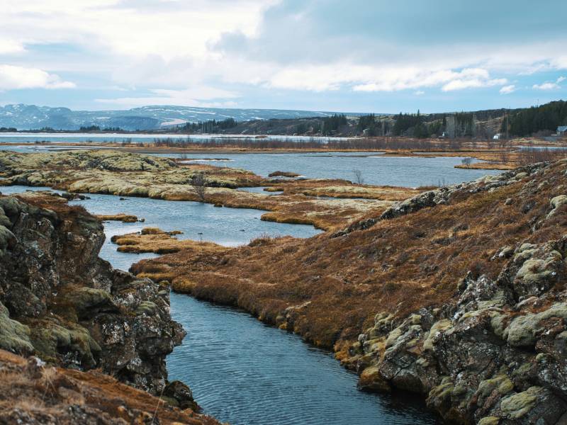 iceland - a river with rocks around it