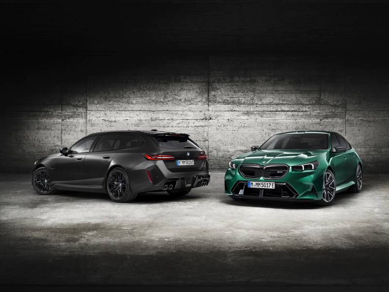 Investment, Tech & Motoring trends 2025 - A matte black BMW M5 Touring and a vibrant green BMW M5 Touring are showcased in an industrial setting, highlighting their sporty design and bold features
